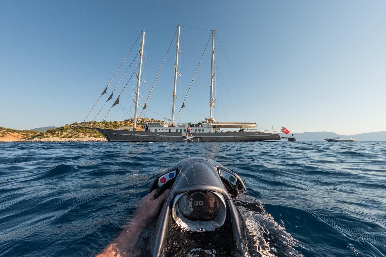 Aegean Yacht 3 Mast Schooner, 2009, sailing near rocky coastline, viewed from watercraft.