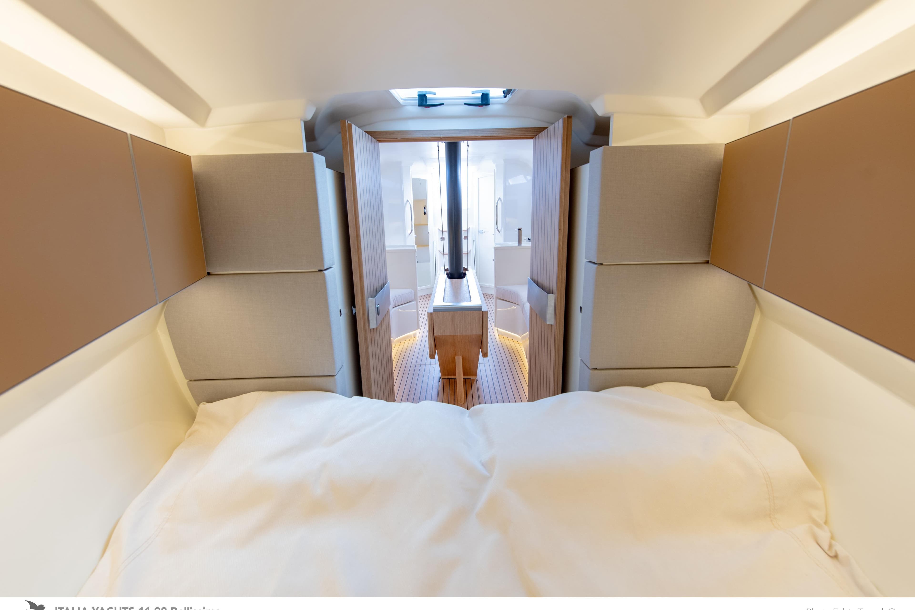 Luxurious interior of 2026 Italia Yachts 11.98, featuring modern design and comfortable bedding.