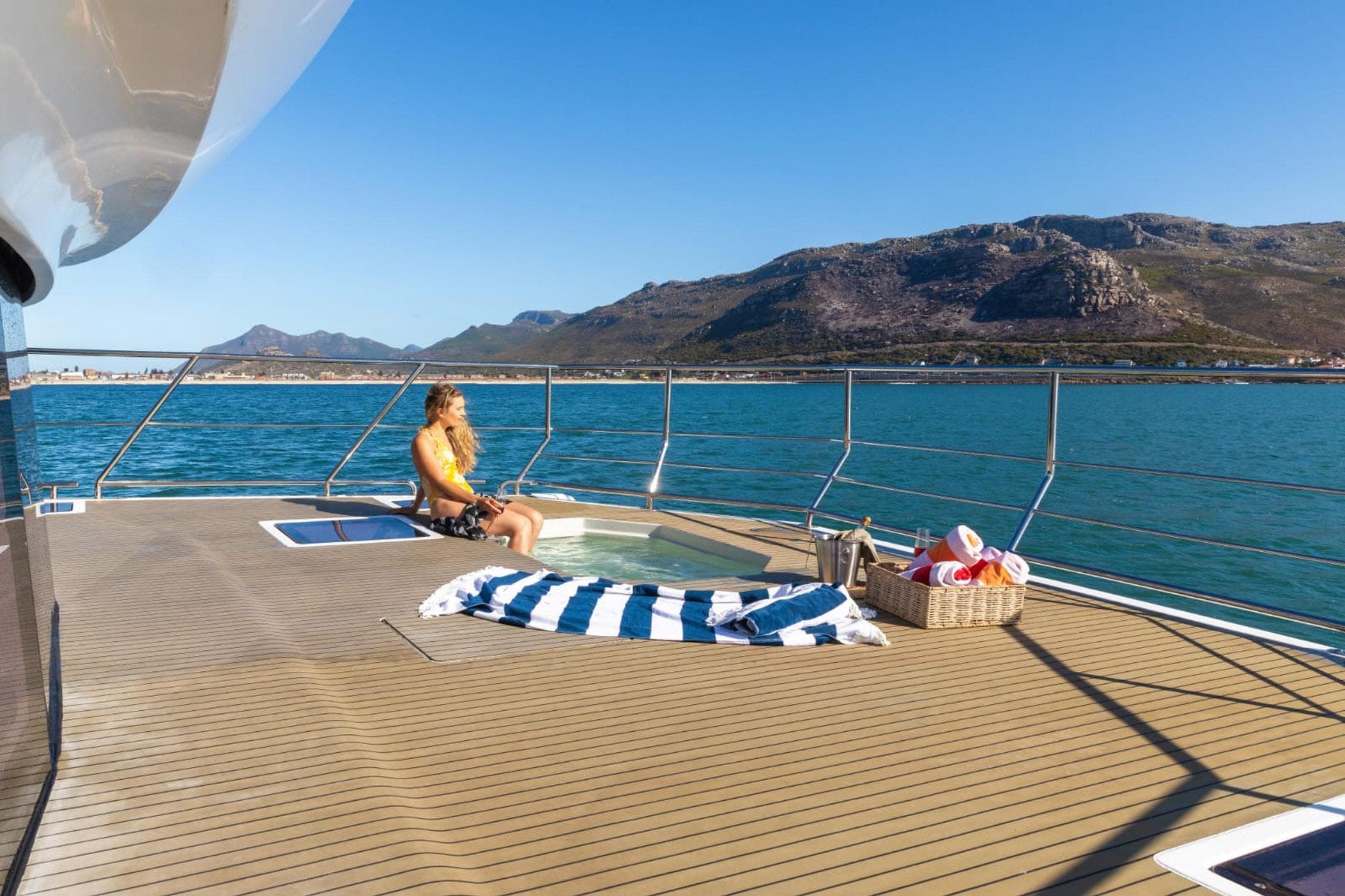 Woman relaxing on Leeuwin 55 yacht with hot tub, 2024 model.