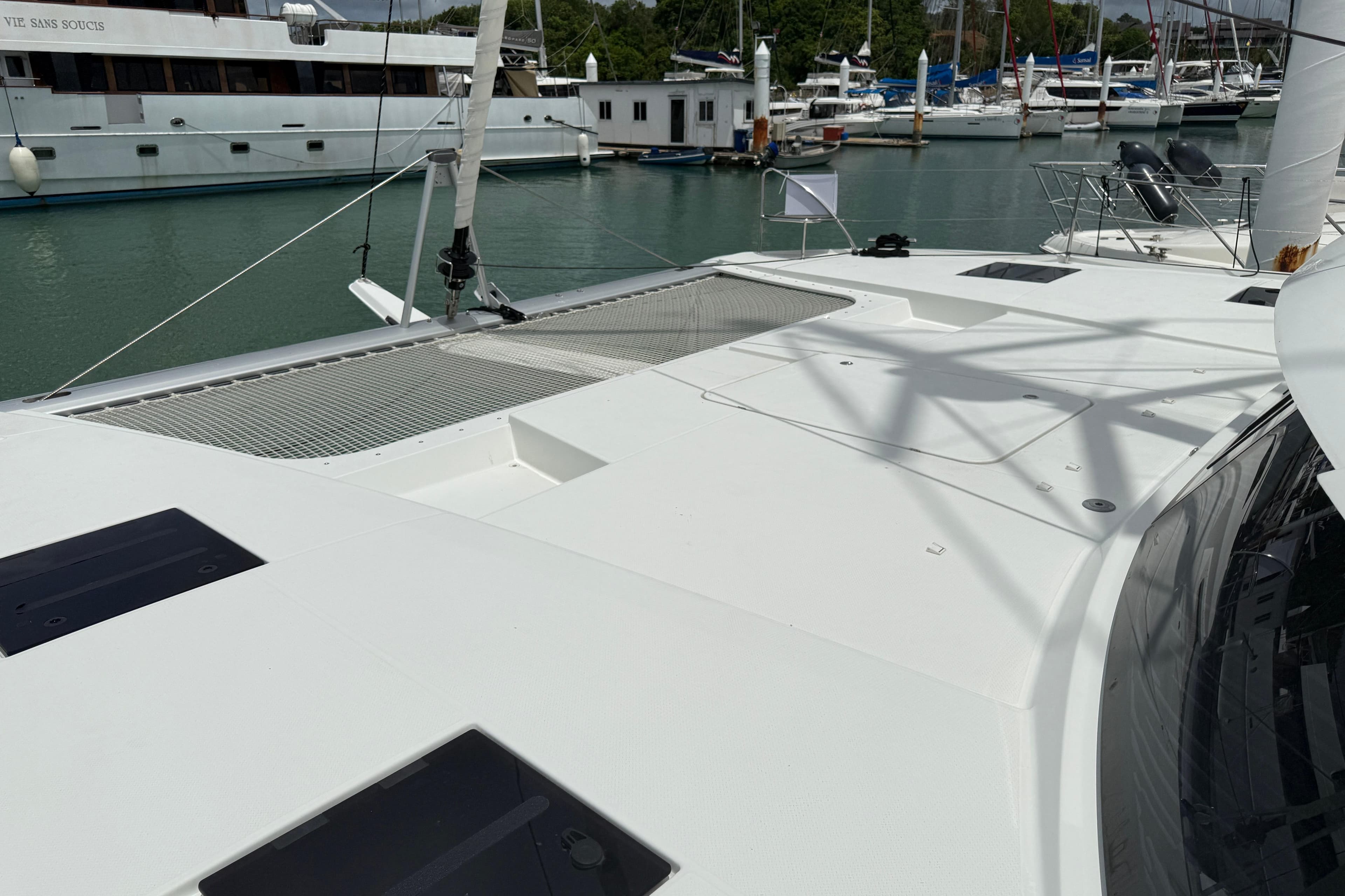 2025 Fountaine Pajot Tanna 47 catamaran docked in a marina, showcasing sleek deck design.