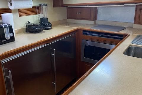 2001 Grand Banks 49 Eastbay SX yacht kitchen with modern appliances and wood cabinetry.