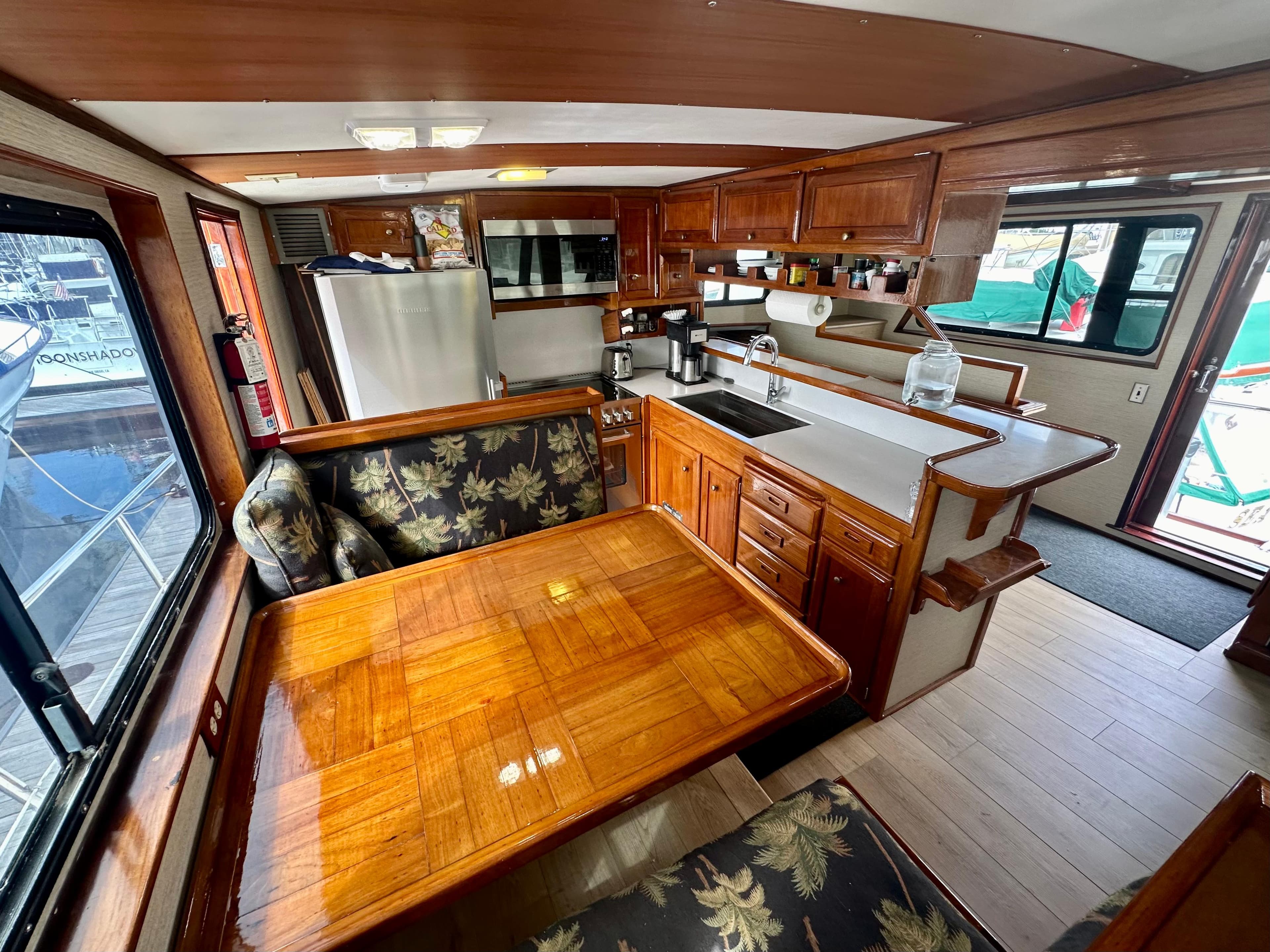 Interior of 1976 Ditmar & Donaldson Custom Yachtfisher with wood finishes and dining area.