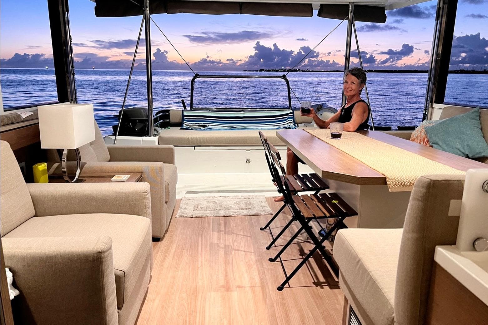 Luxurious Bali 4.2 yacht interior with ocean view, featuring comfortable seating and a dining area.