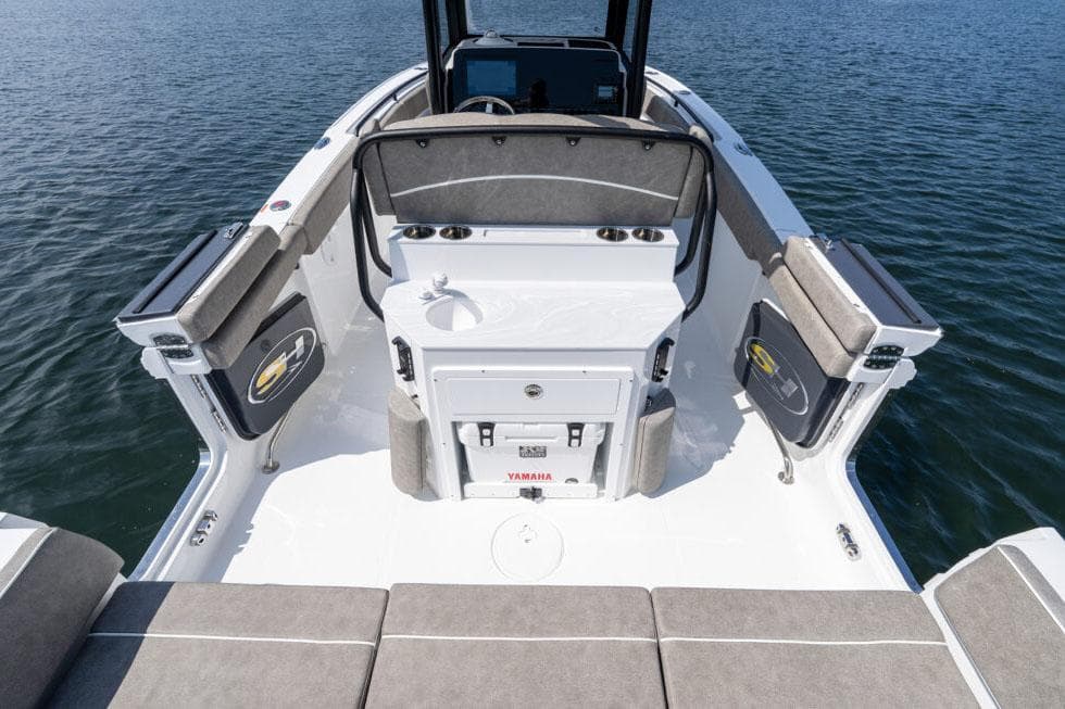 Manufacturer Provided Image: 2026 Sea Hunt Ultra 255 SE boat interior with seating and storage, on calm water.