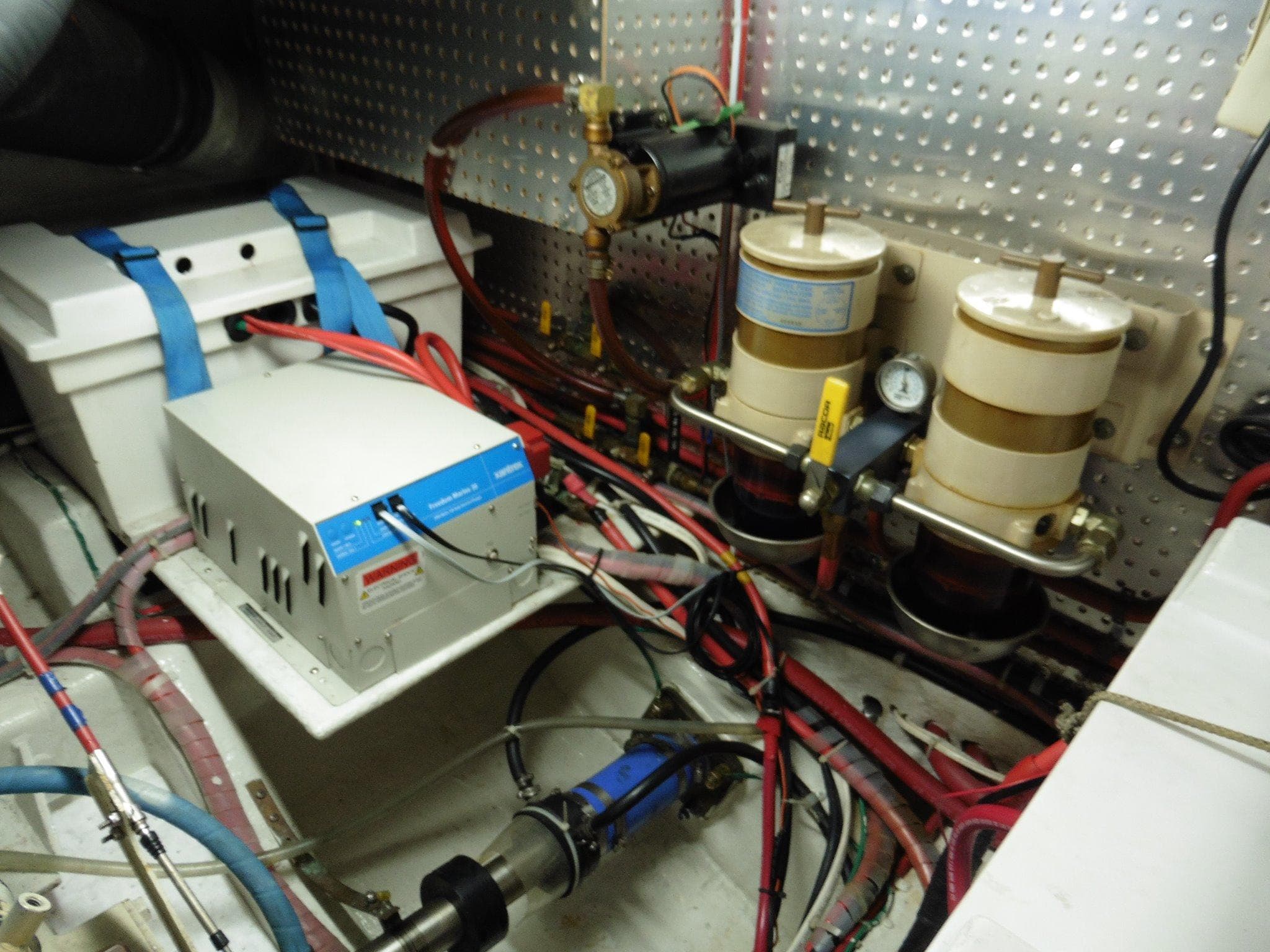 Engine room of 2000 Novatec Cockpit Motor Yacht with fuel filters and electrical components.