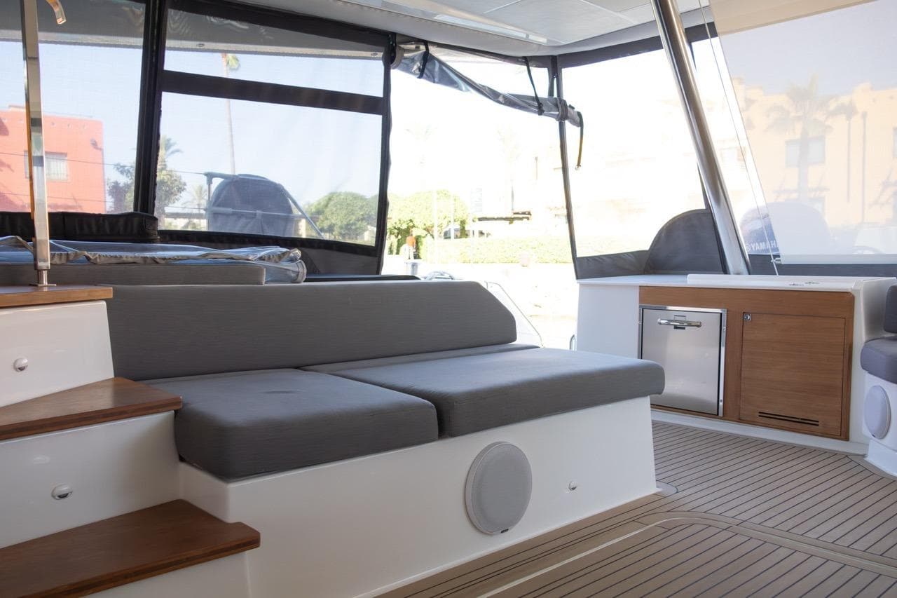Luxurious interior of 2023 Fountaine Pajot Samana 59 yacht with modern seating and cabinetry.