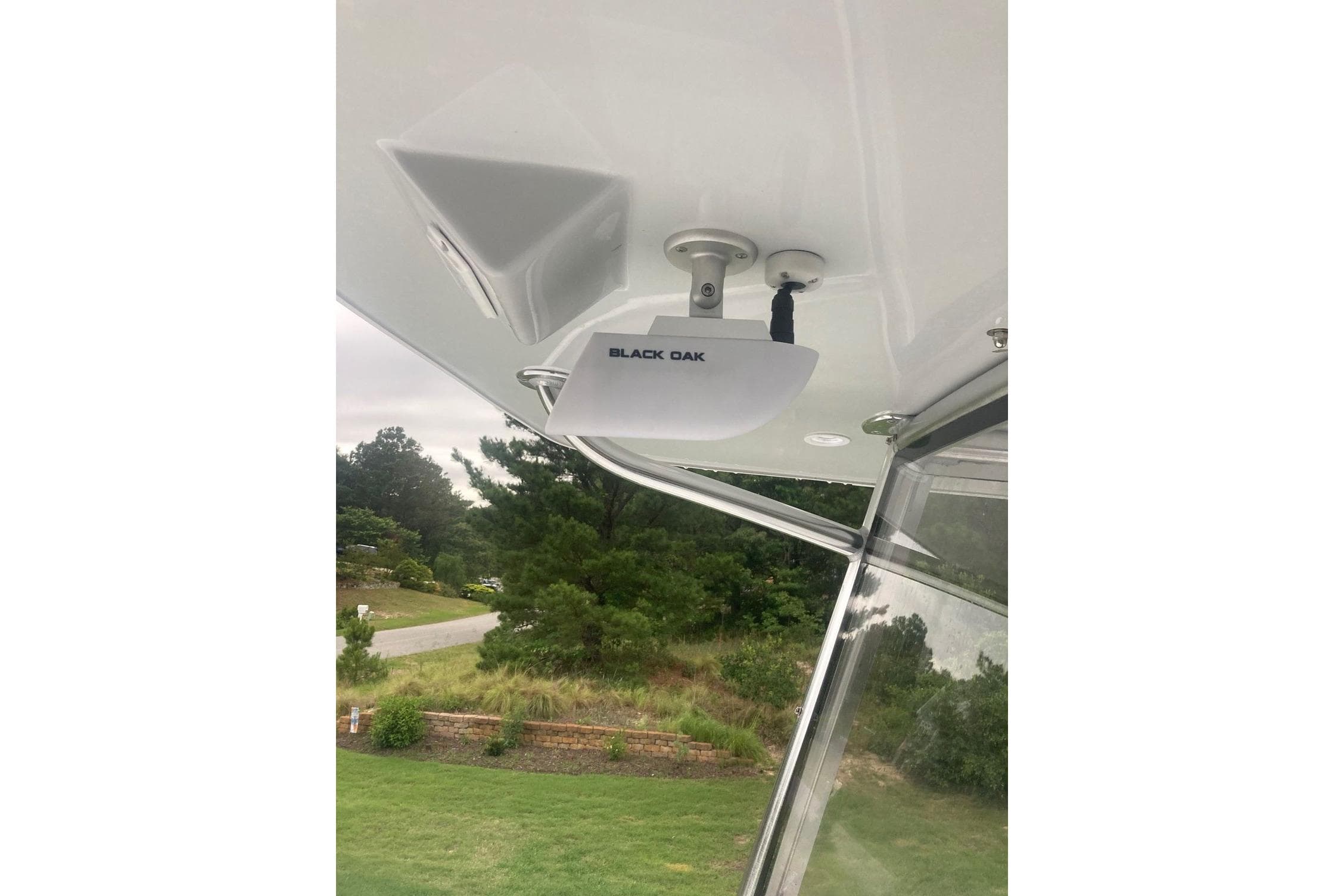 2022 Sea-Lion 34 TE boat with Black Oak light fixture, outdoor setting.
