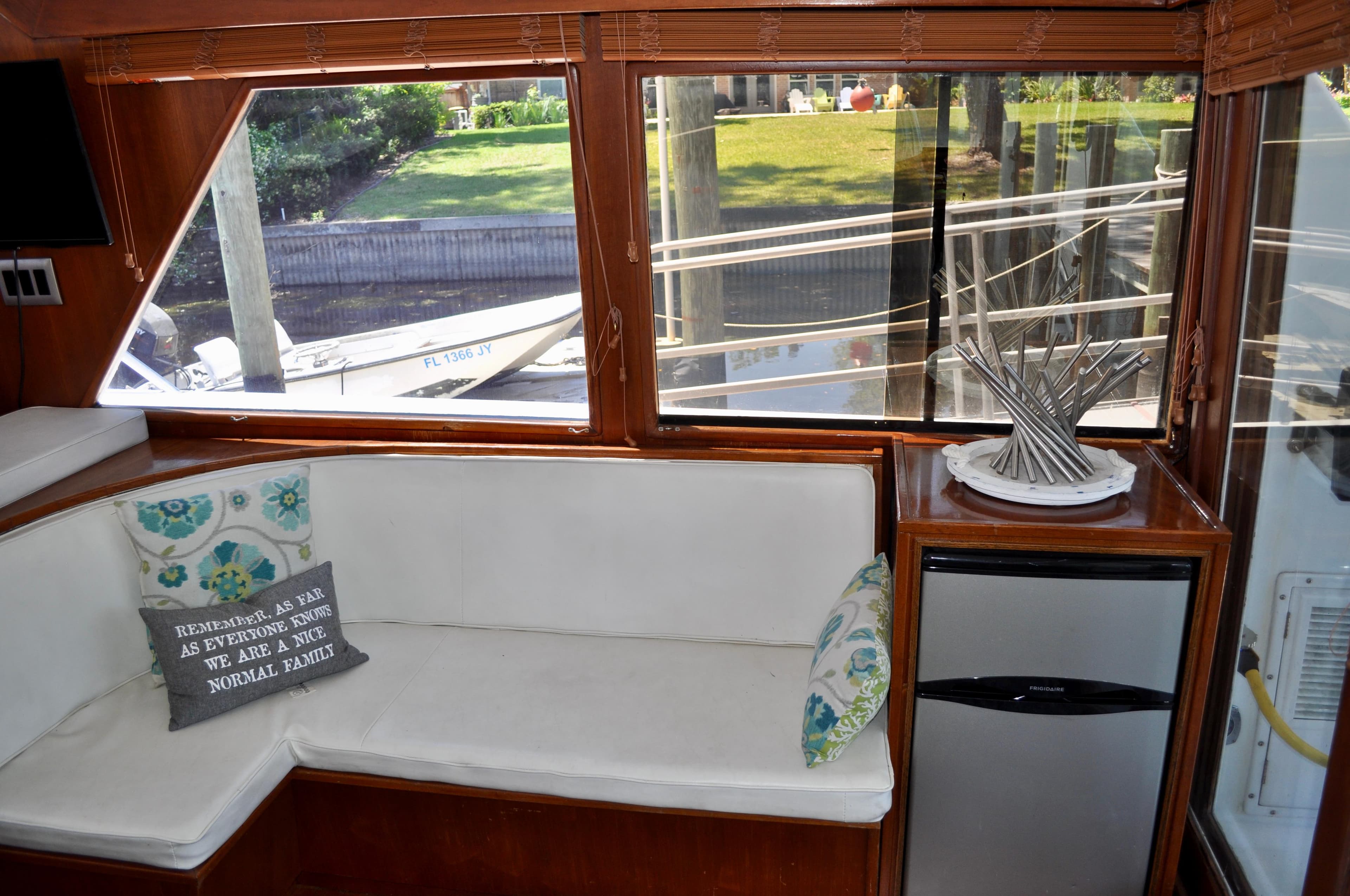 Interior of 1990 Ocean Alexander 42 Sedan with white seating and decorative pillows.