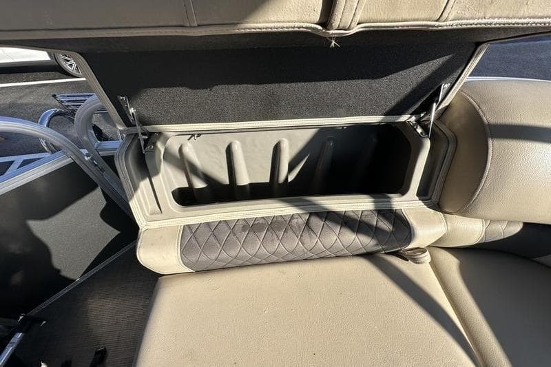 Open storage compartment in 2023 Sun Tracker Party Barge 20 DLX boat seat.