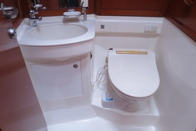 Compact bathroom in 2003 Nautor Swan 56 R yacht with sink and toilet.