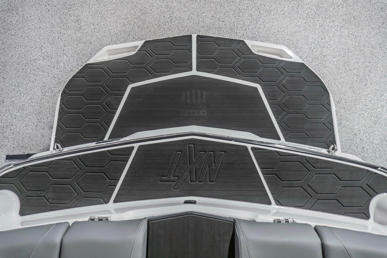 2026 MasterCraft NXT20 boat deck with hexagonal pattern and logo.