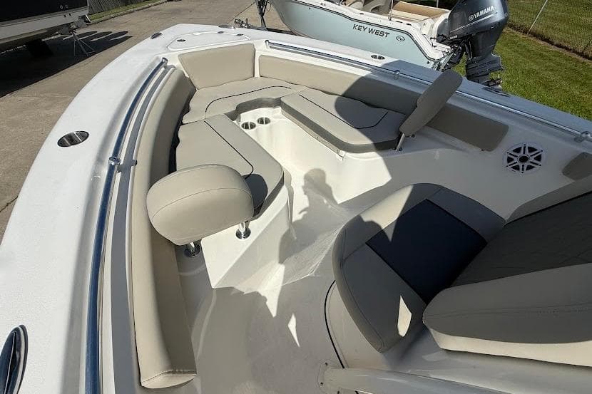 2026 Key West 219 FS boat interior with cushioned seating and cup holders.