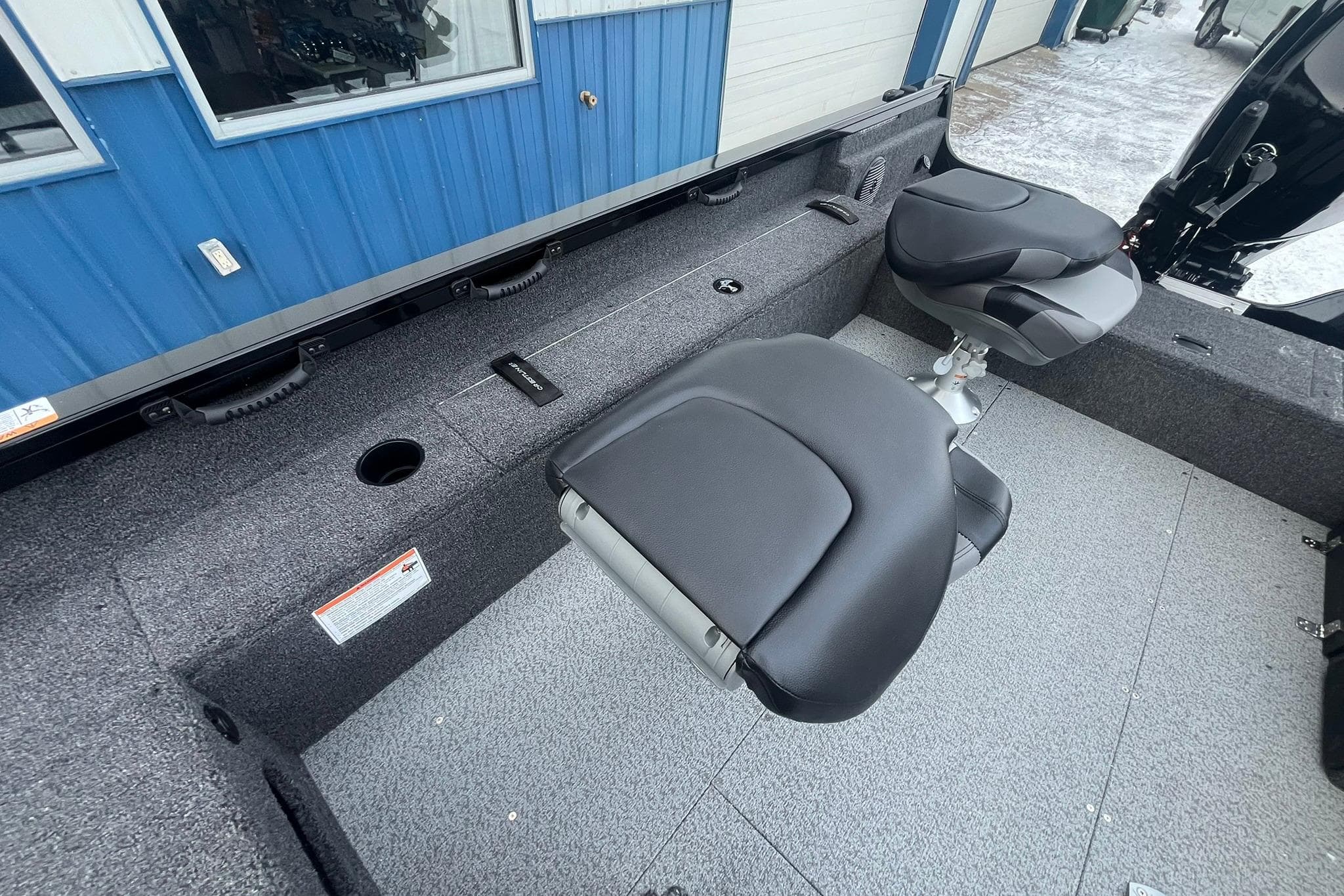 2026 Crestliner 1650 Pro Tiller interior with two swivel seats and carpeted flooring.