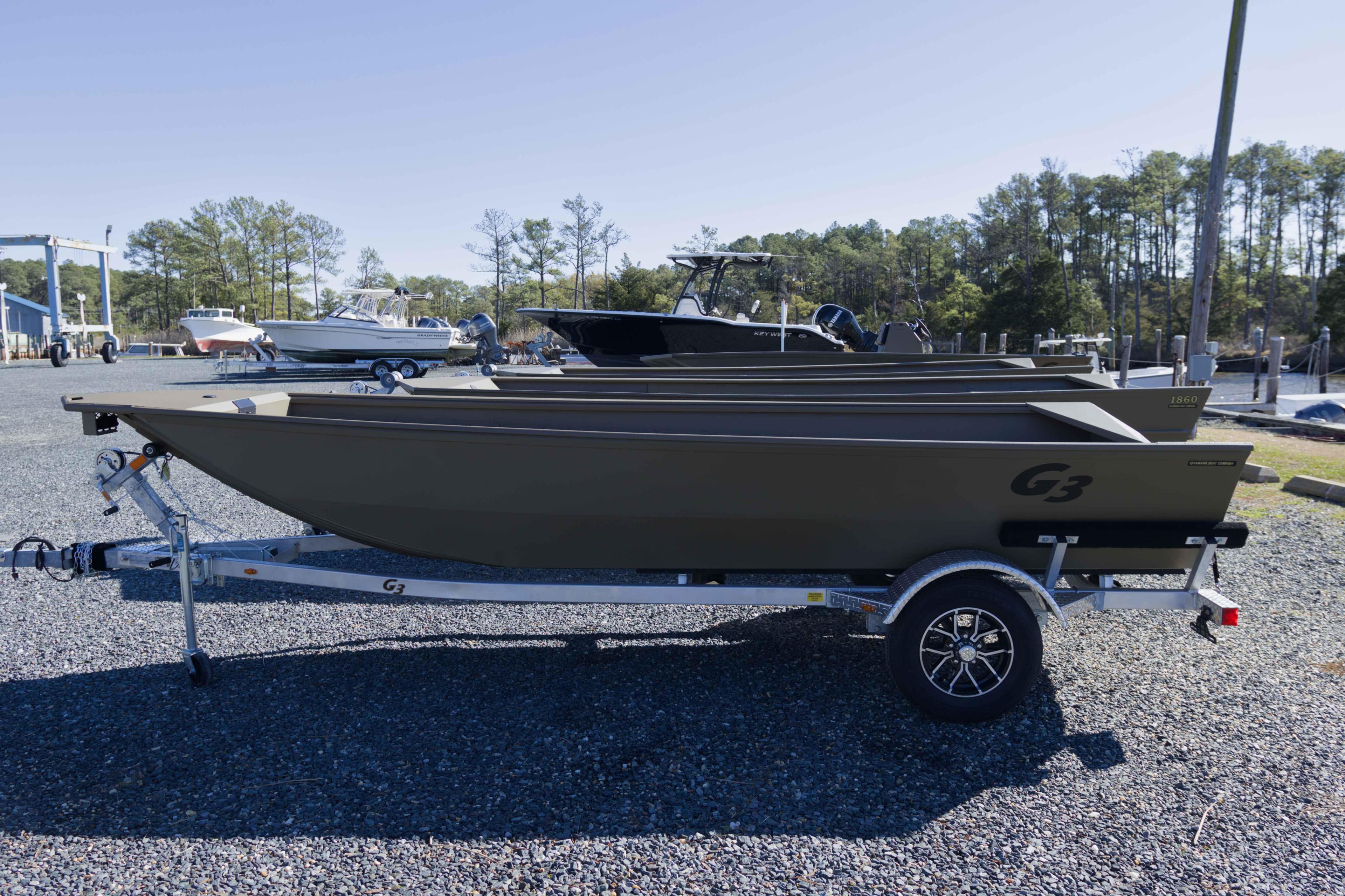 2026 G3 Gator Tough 17 DK boat on trailer, parked outdoors.
