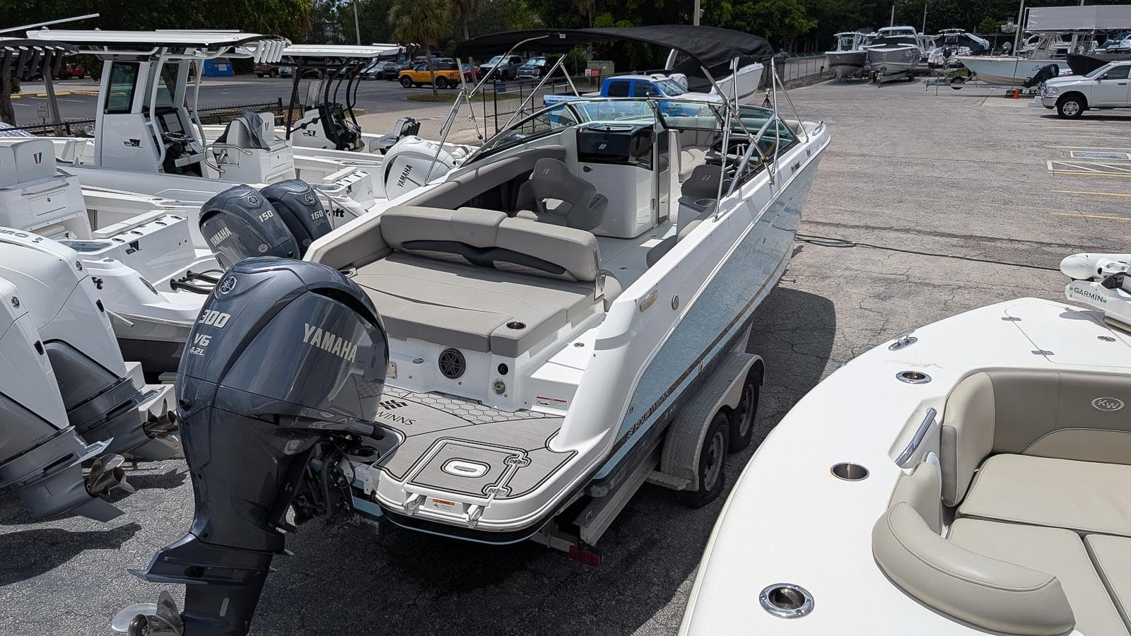 2024 Four Winns HD8 OB boat with Yamaha outboard motor in a marina setting.