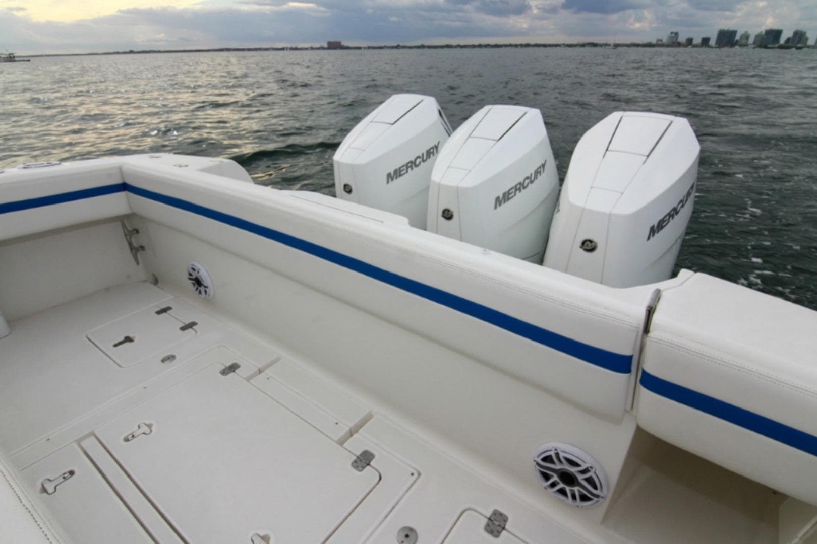 2003 Intrepid 377 Walkaround boat with triple Mercury engines on open water.