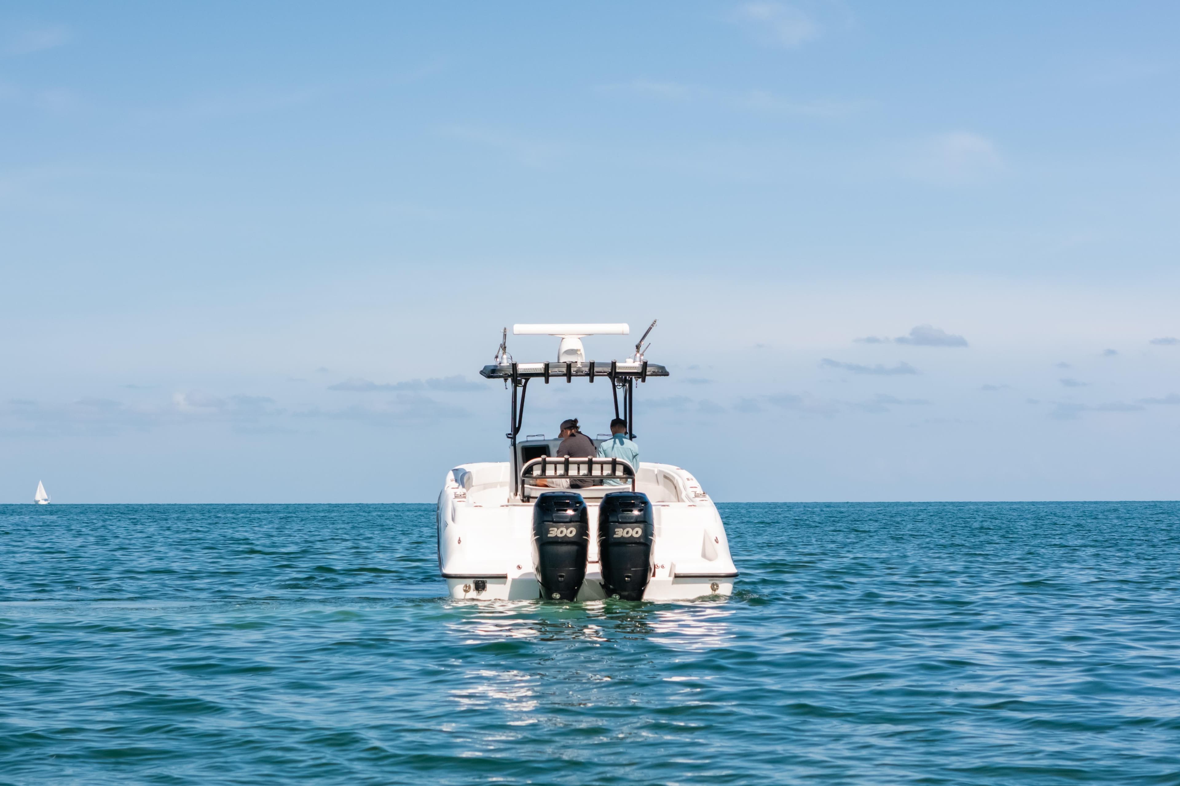 Deep Impact 33 boat from 2013 on open sea, clear sky, rear view.