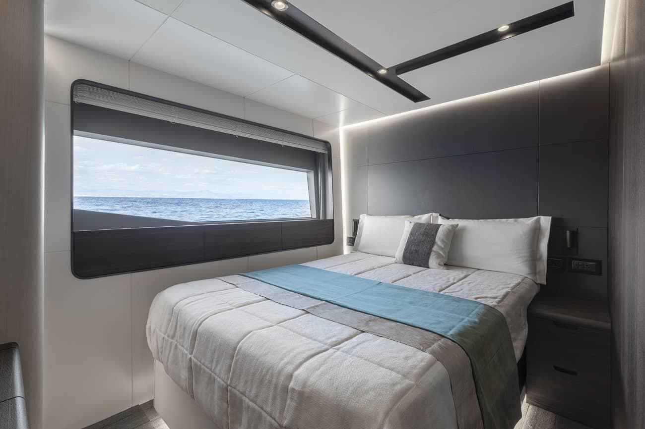 Luxurious bedroom in 2023 Astondoa AS8 Flybridge yacht with ocean view.