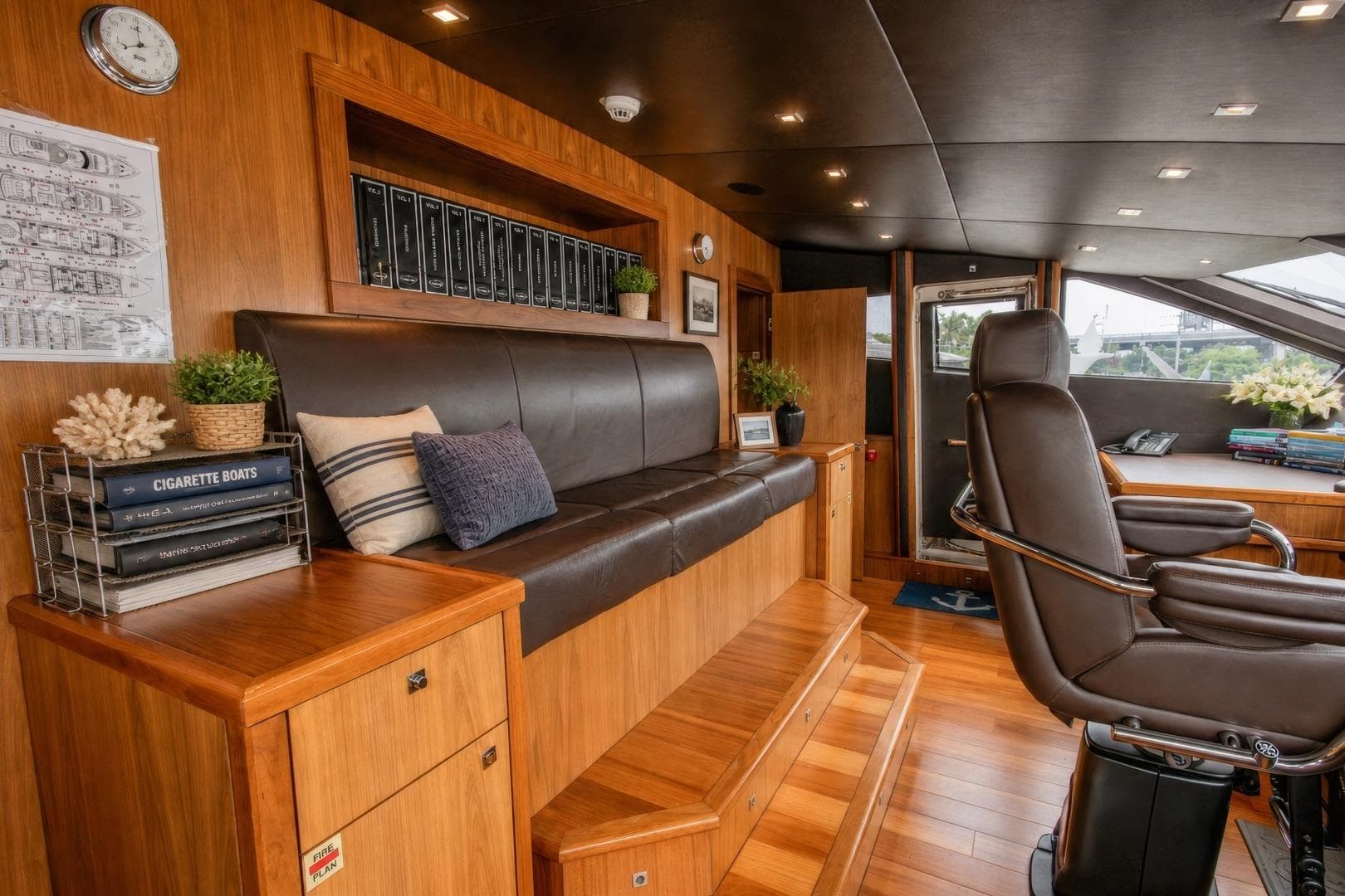 Luxurious interior of 2014 Sunseeker 131 Yacht with leather seating and wooden accents.