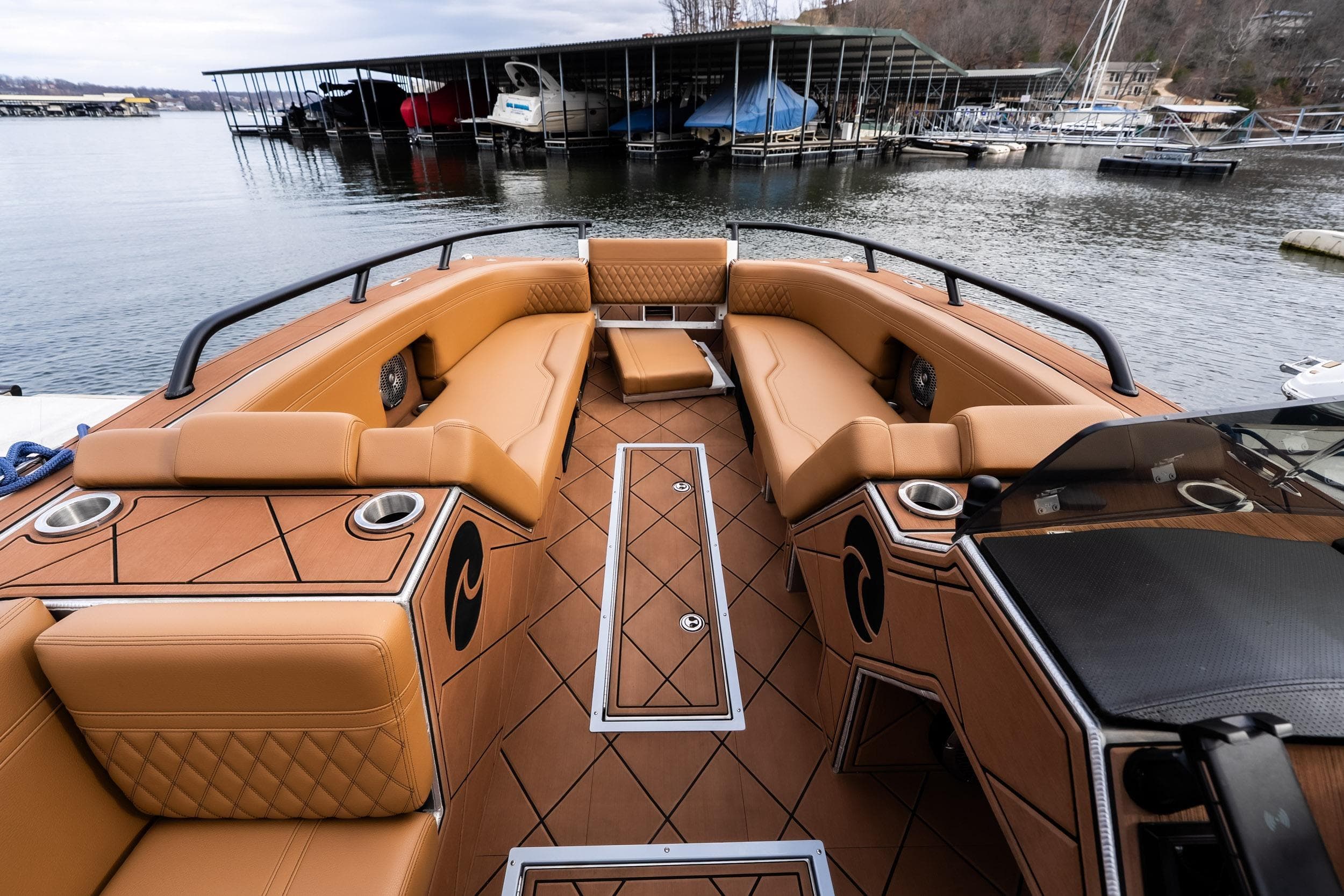Luxurious 2026 Anthem Assault ST23 boat interior with tan seating and lake view.
