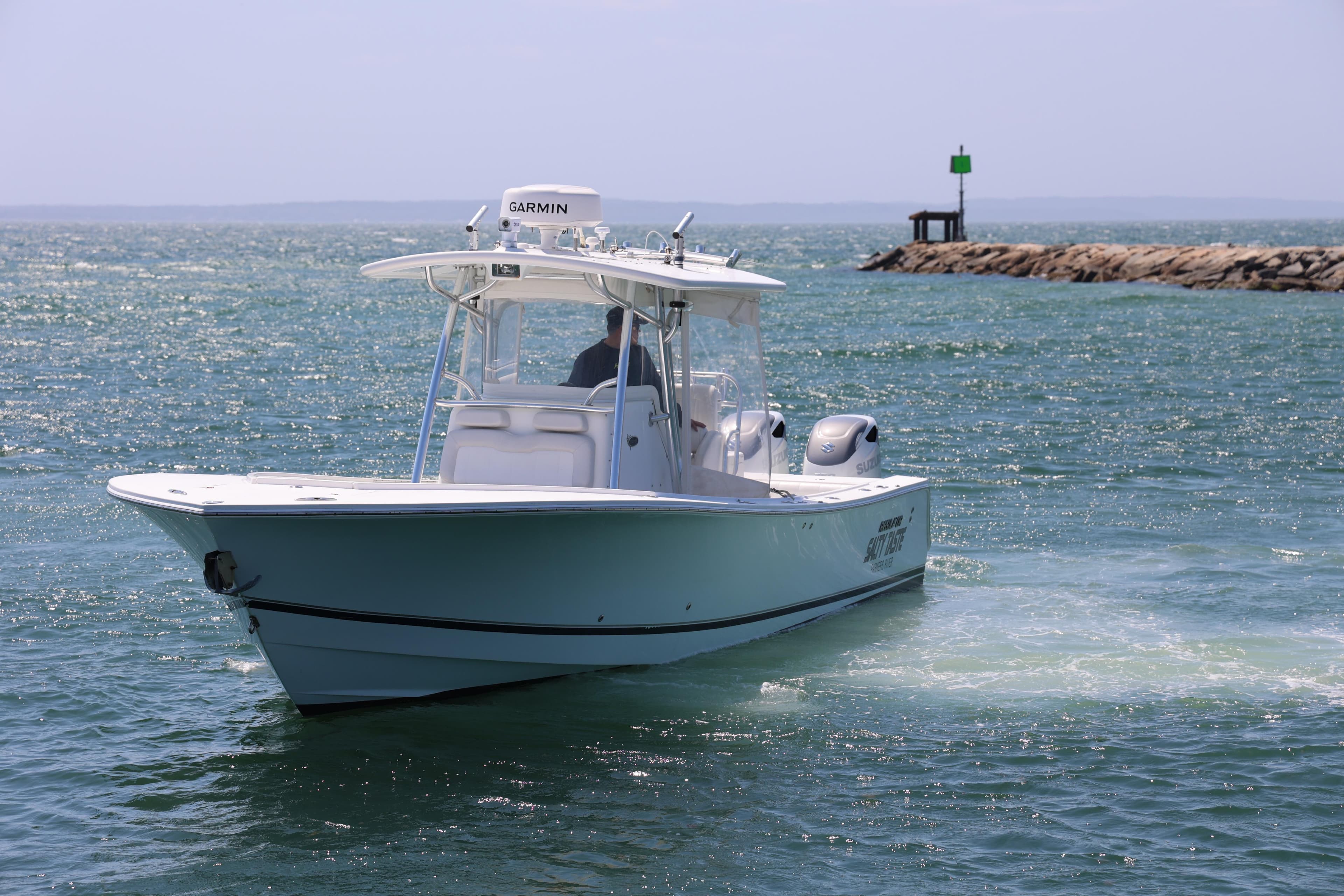 2009 Regulator 32 Forward Seating boat navigating coastal waters.