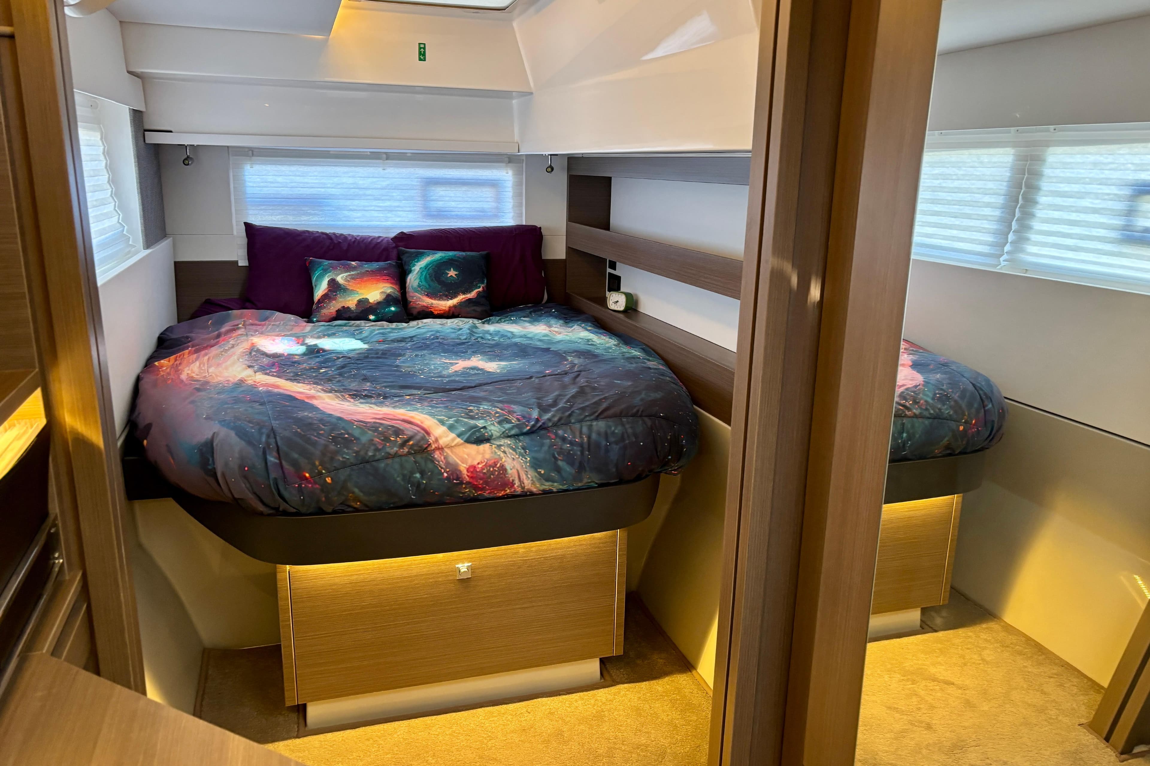 Luxurious bedroom interior of 2022 Leopard 42 yacht with cosmic-themed bedding.