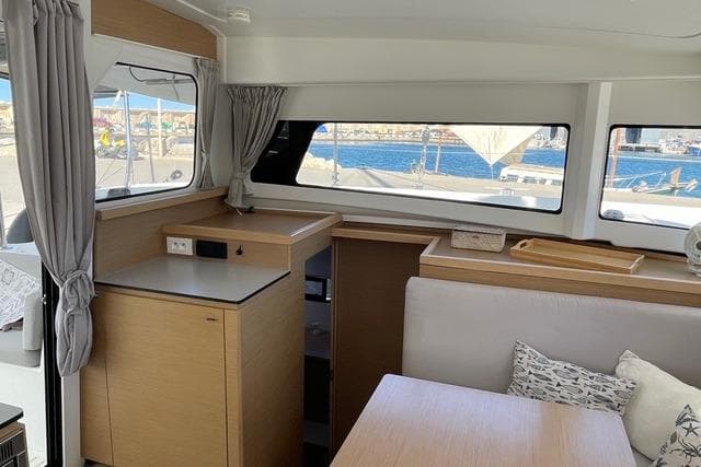 Modern interior of 2021 Excess 11 yacht with wooden cabinetry and ocean view.