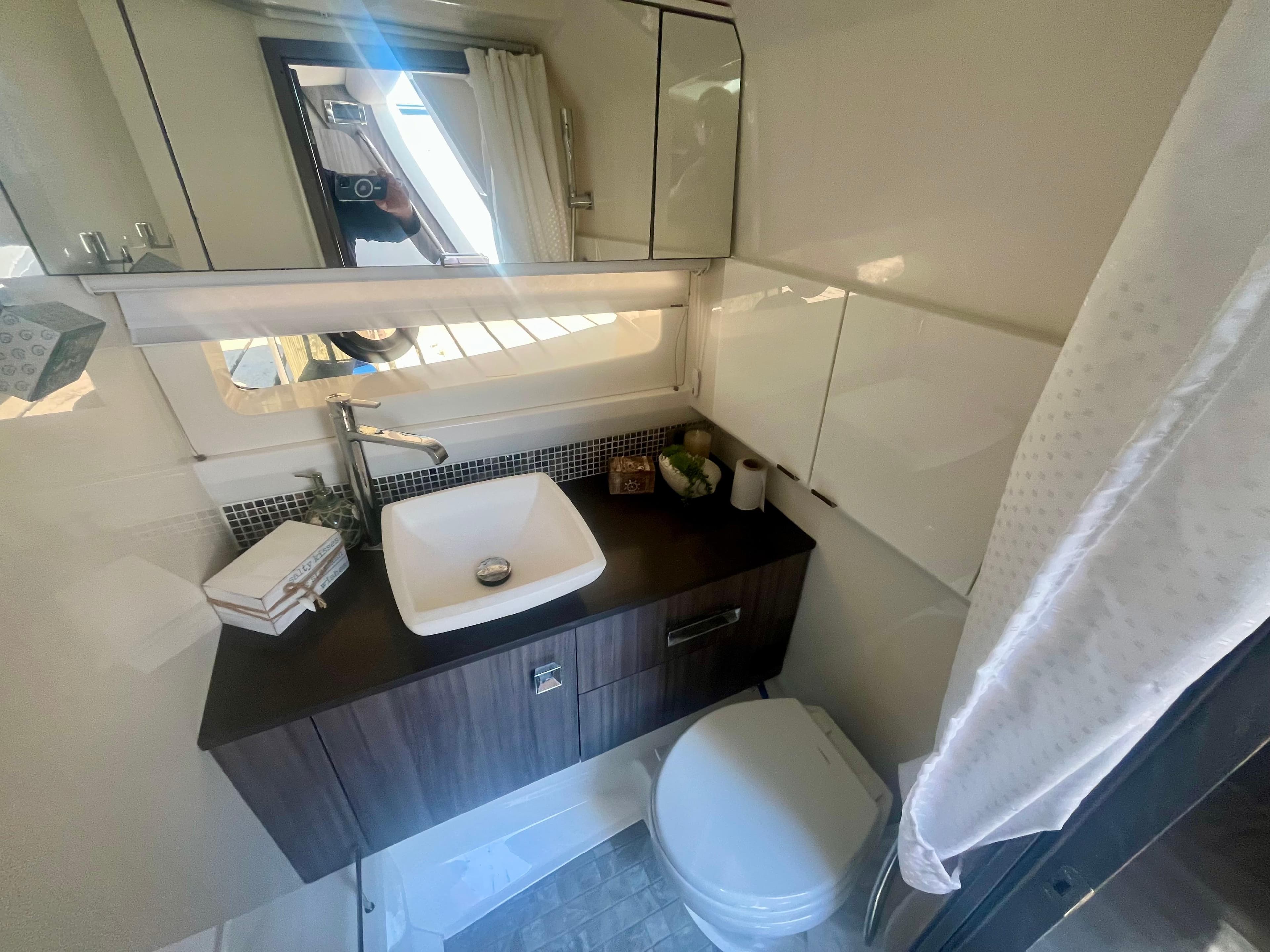 Luxurious bathroom in 2018 Sea Ray SLX 400 yacht with modern sink and toilet.