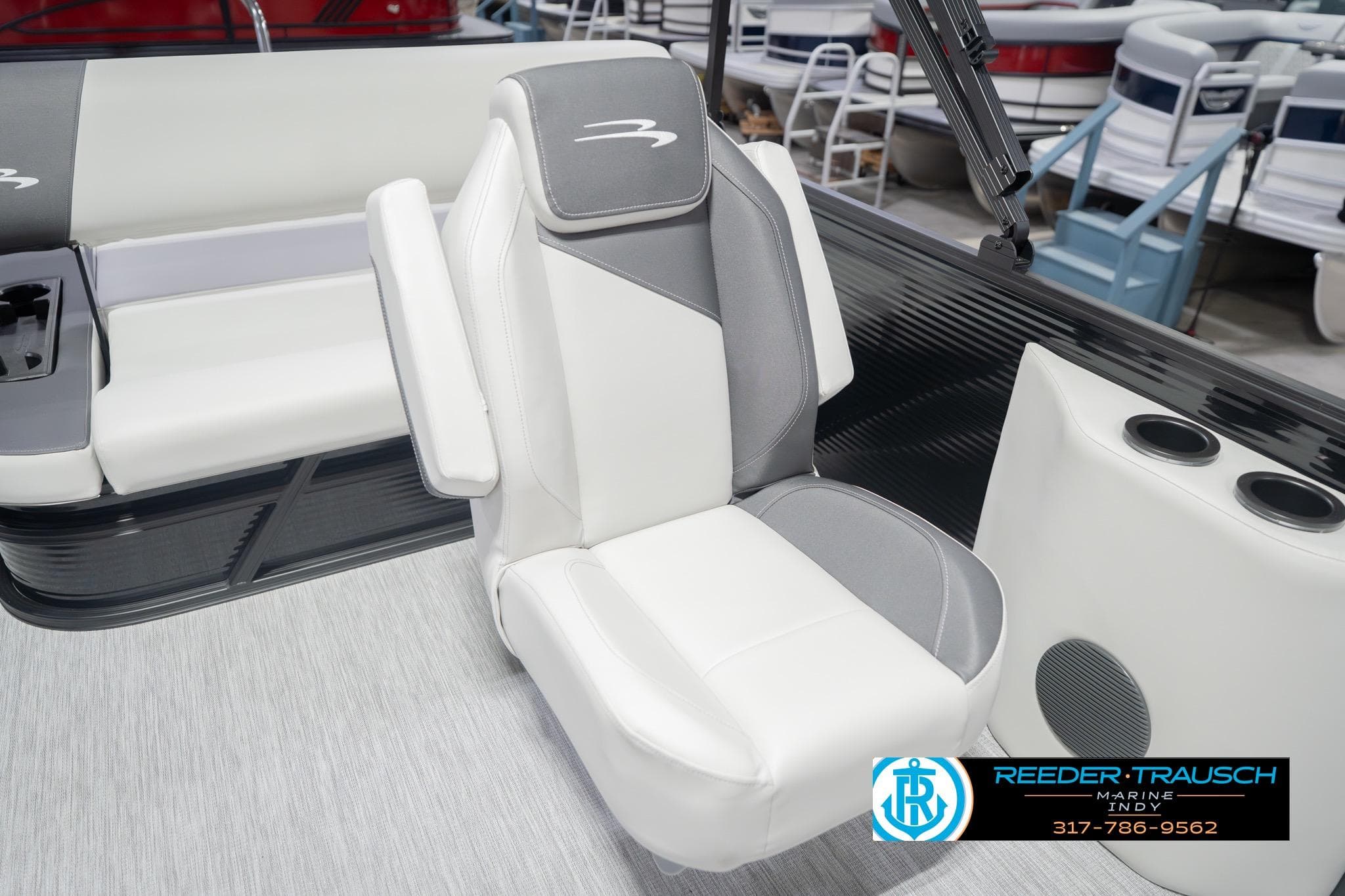 2026 Bennington 22 SSB boat interior with white and gray seating, cup holders, and logo.