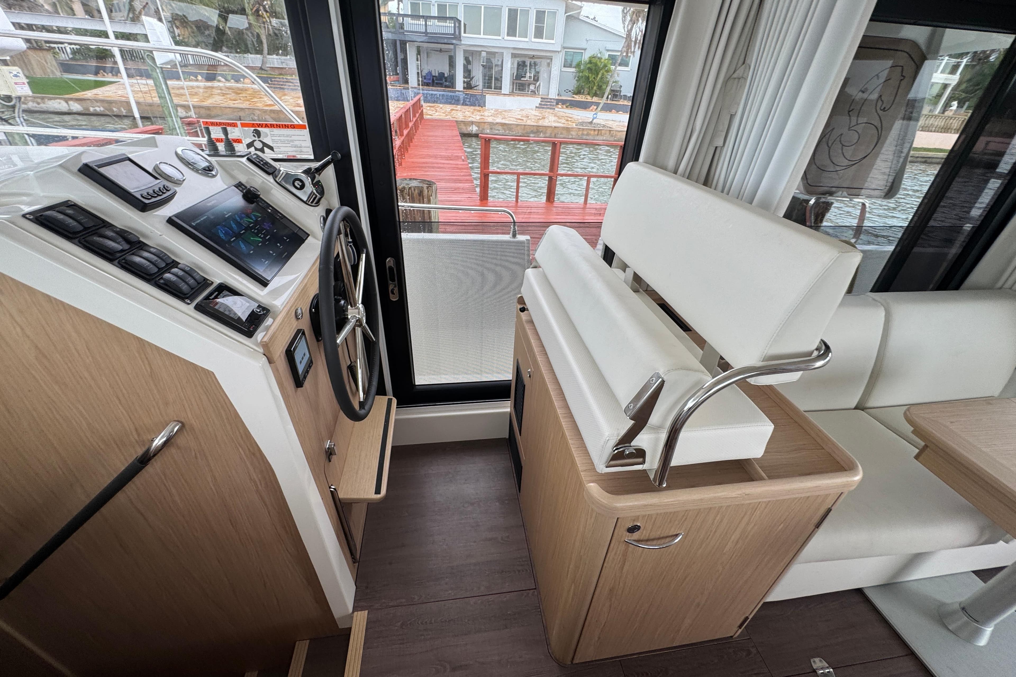 Interior of 2023 Beneteau Swift Trawler 35, featuring helm station and seating.