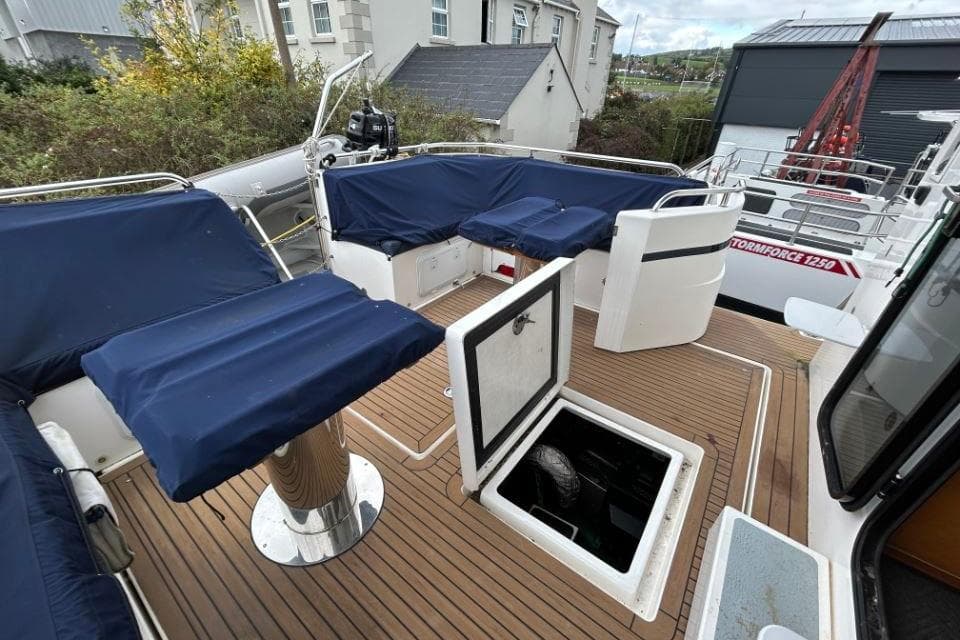 2018 Redbay Boats 1650 Explorer Cabin RIB with blue seating and open hatch on deck.