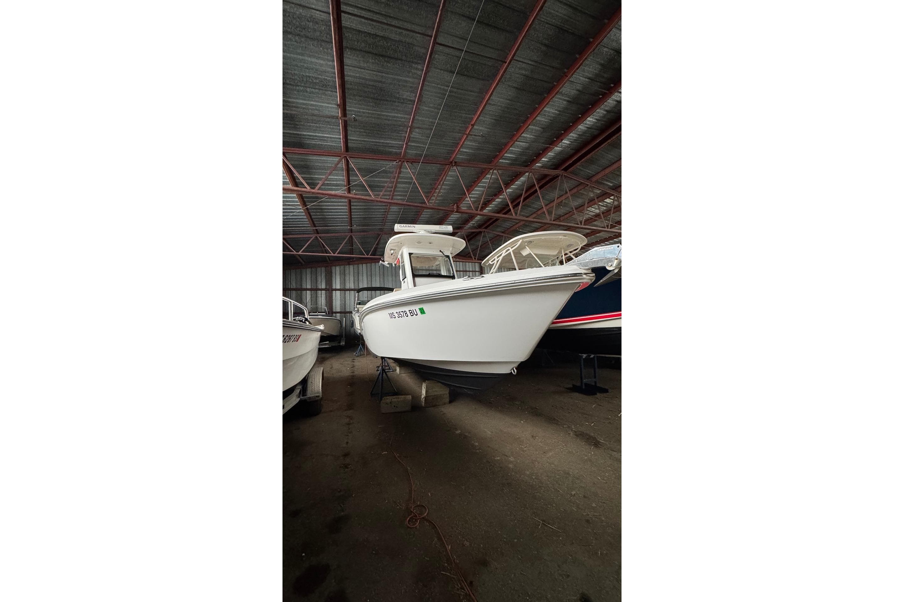 2016 Everglades 255 Center Console boat in storage, side view.