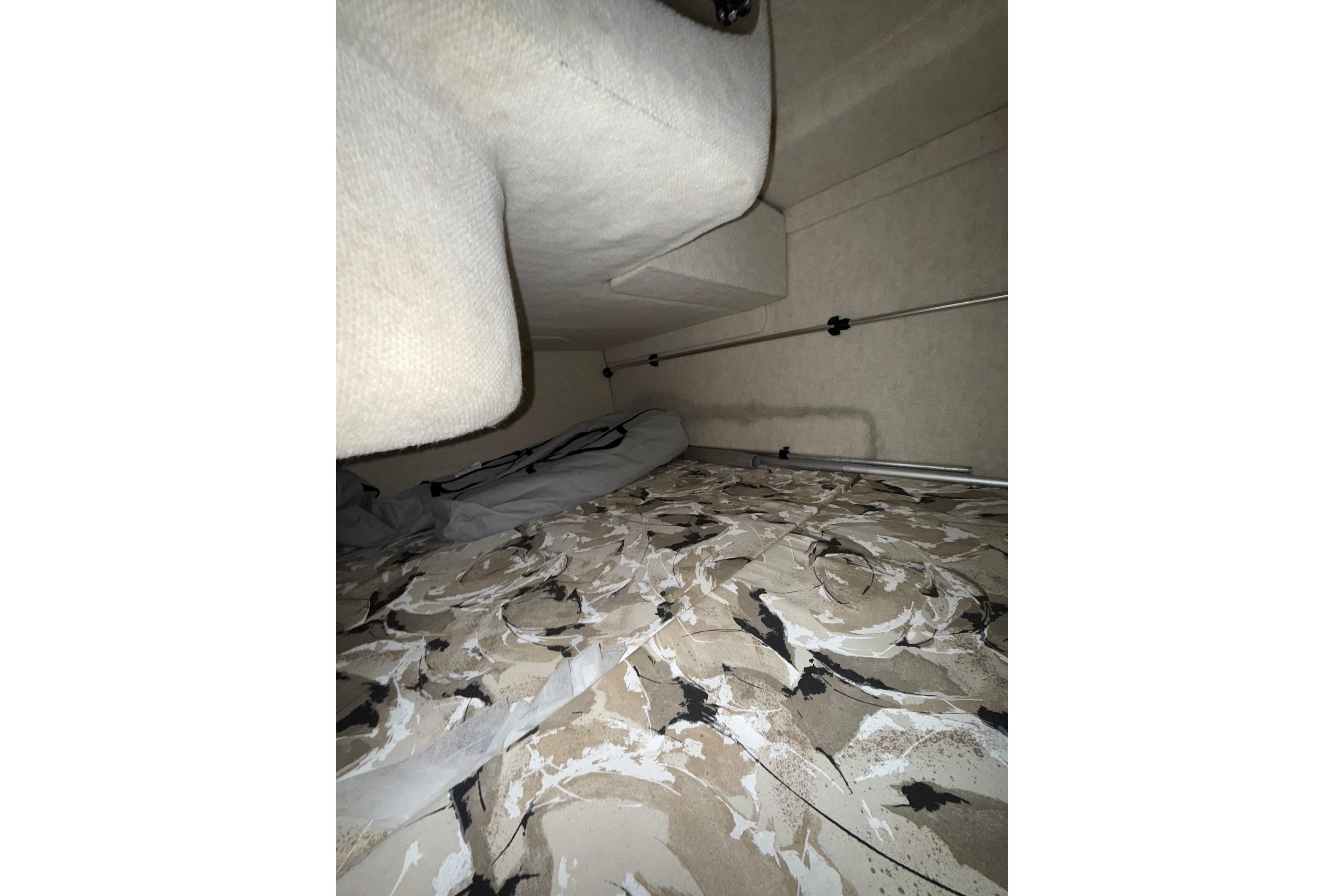 Interior cabin of 2000 Sea Ray 240 Sundancer with patterned bedding.