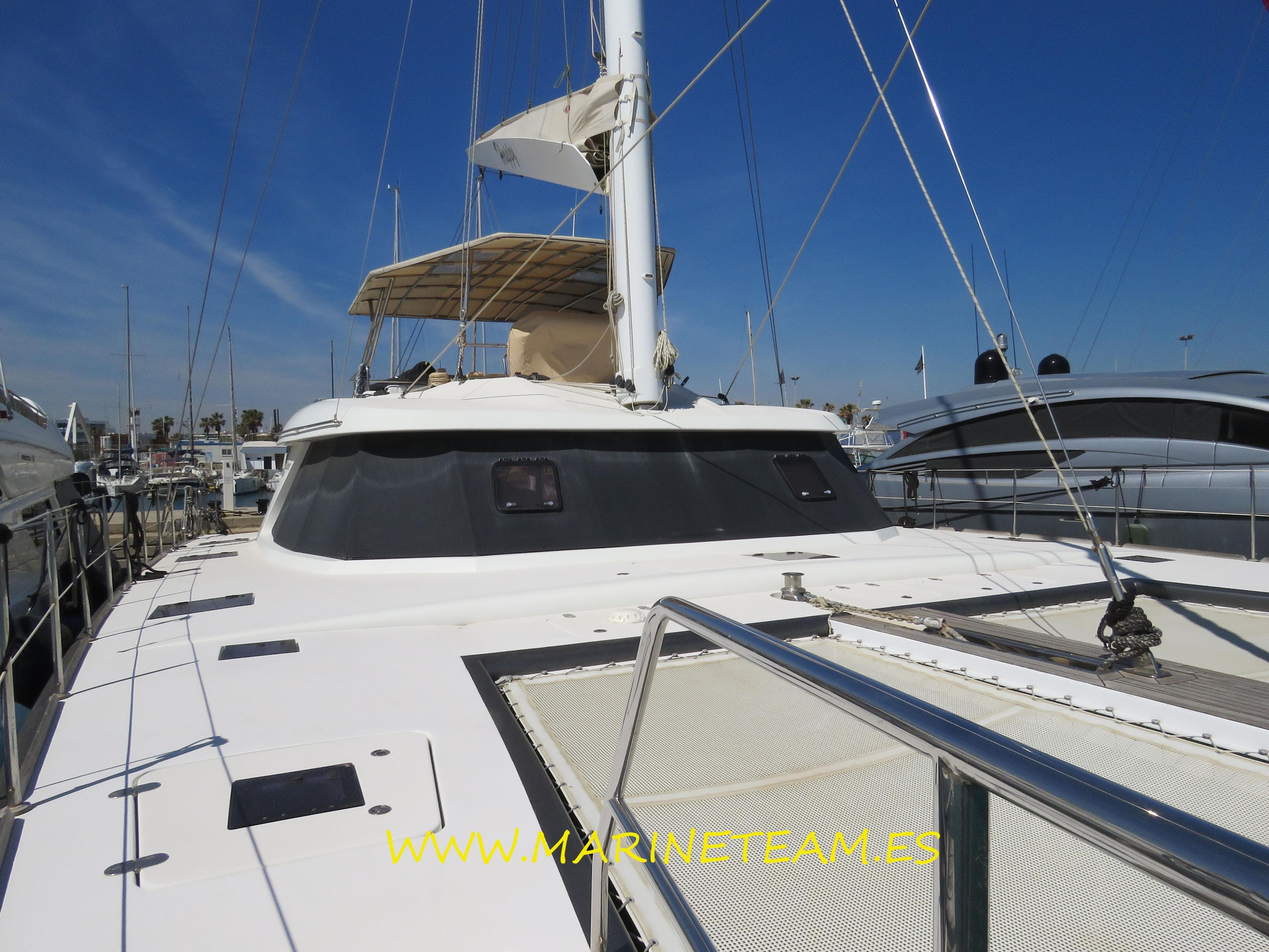 2015 Sunreef 60 LOFT catamaran docked, showcasing sleek design and spacious deck.