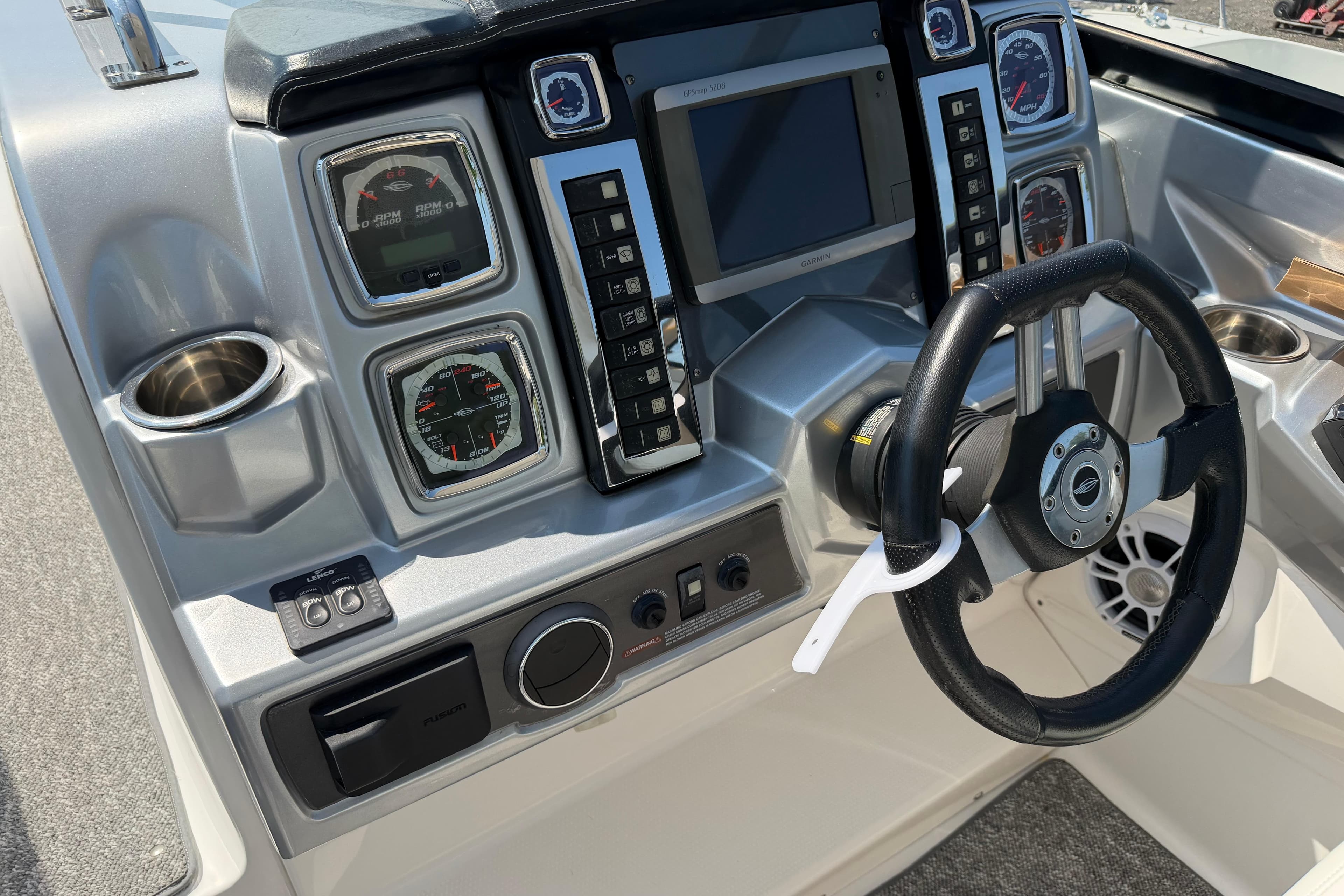Dashboard of a 2012 Chaparral 327 SSX boat with steering wheel and gauges.