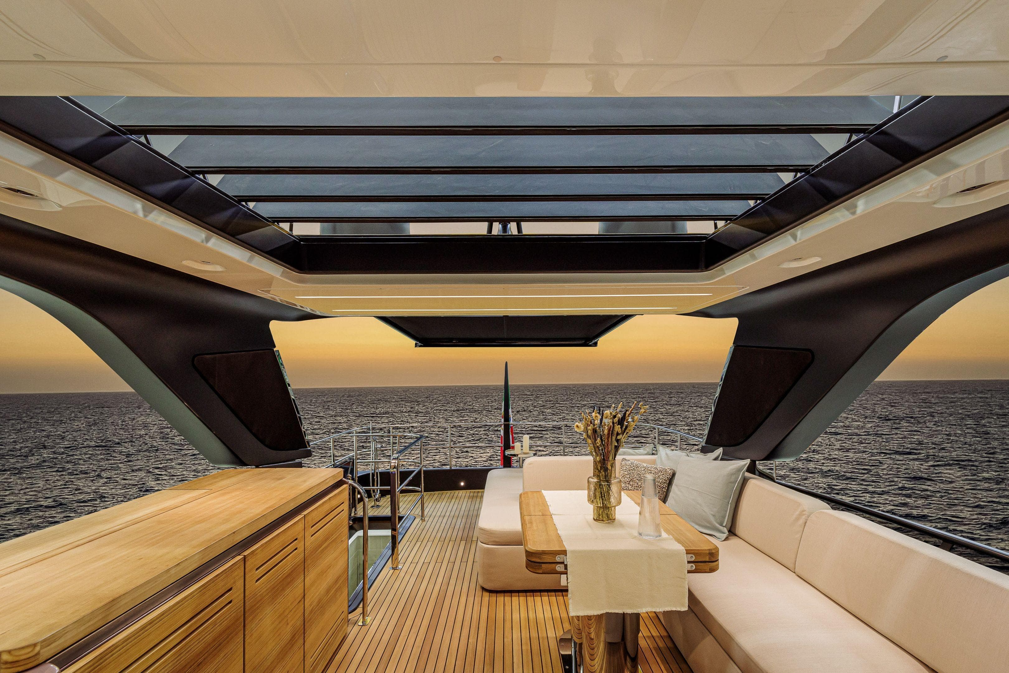 Luxurious interior of 2026 Cranchi Sessantadue 62 yacht with ocean view at sunset.