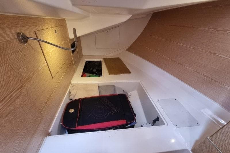 Interior storage area of a 2012 Hanse 445 sailboat with wooden paneling.