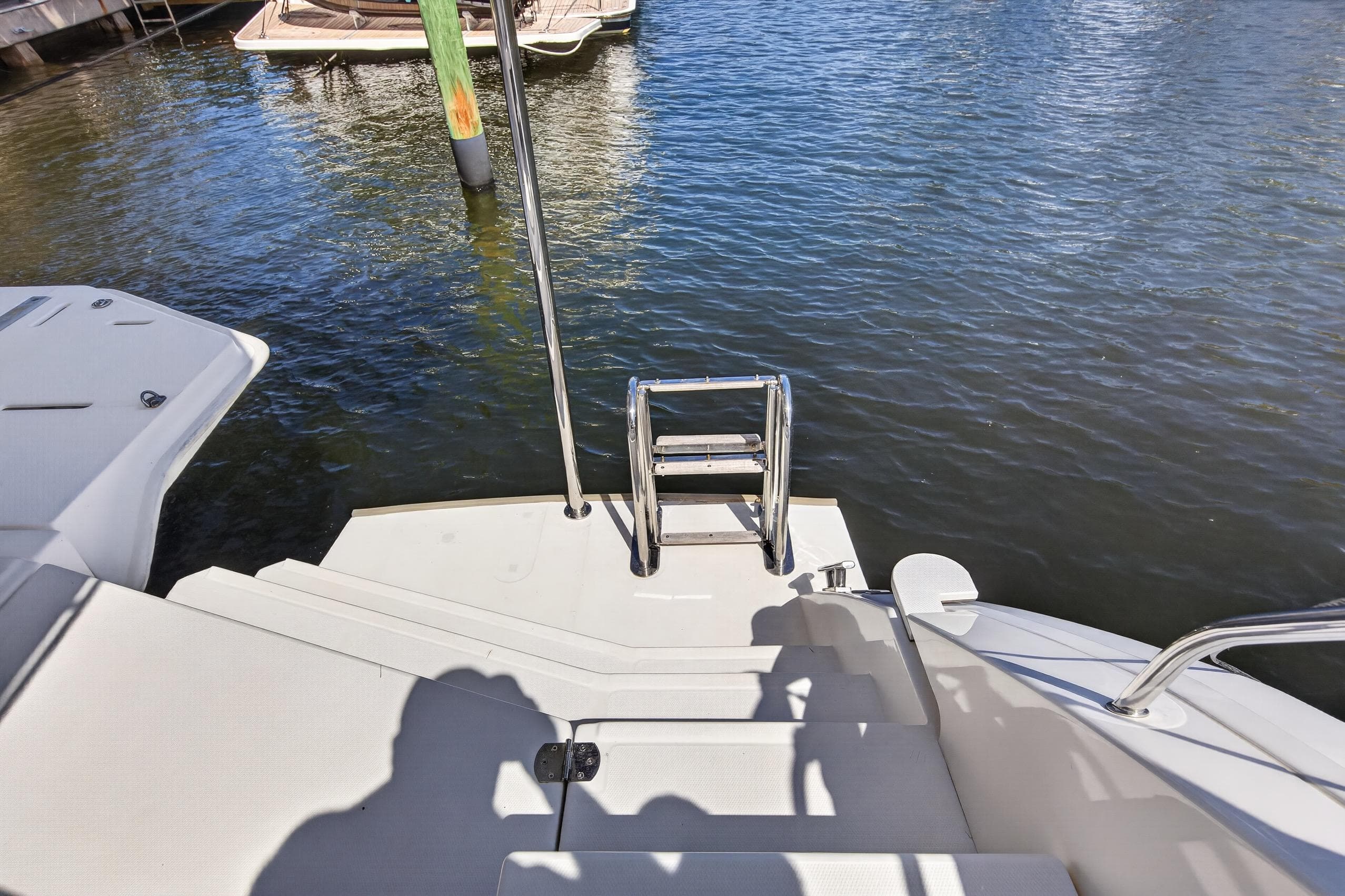 Steps and ladder on a 2022 Leopard 50 yacht, leading to water.