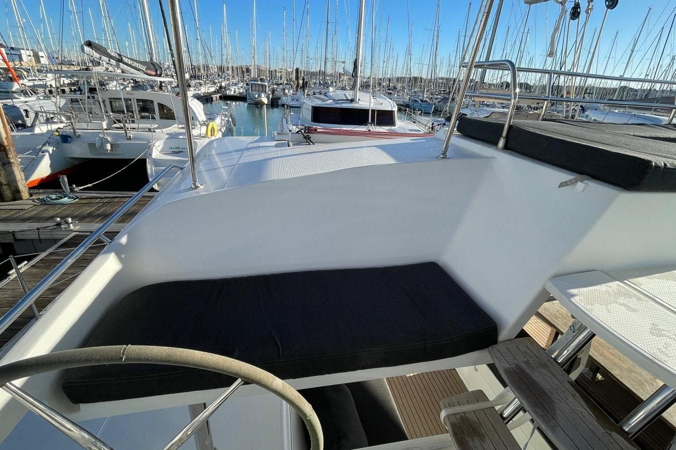 2018 Fountaine Pajot SABA 50 yacht interior with seating, docked in marina.
