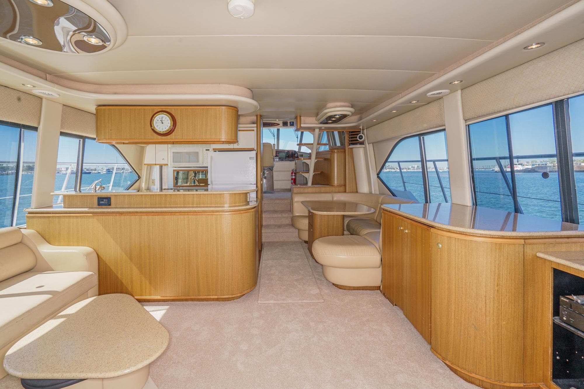 Luxurious interior of 2000 Bayliner 5788 Pilot House Motoryacht with panoramic windows and elegant furnishings.