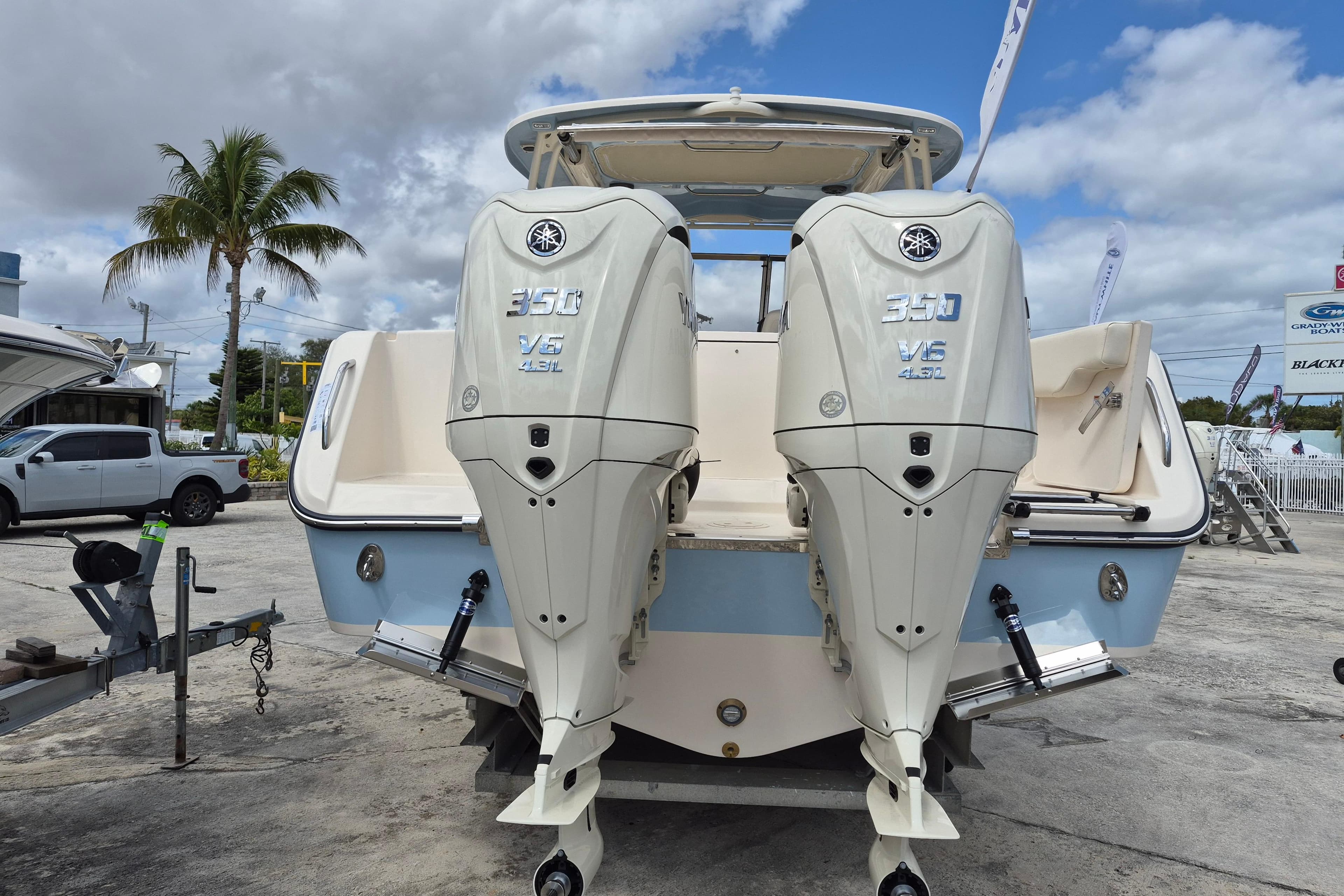 2026 Grady-White Freedom 307 boat with twin 350 V6 engines, parked outdoors.