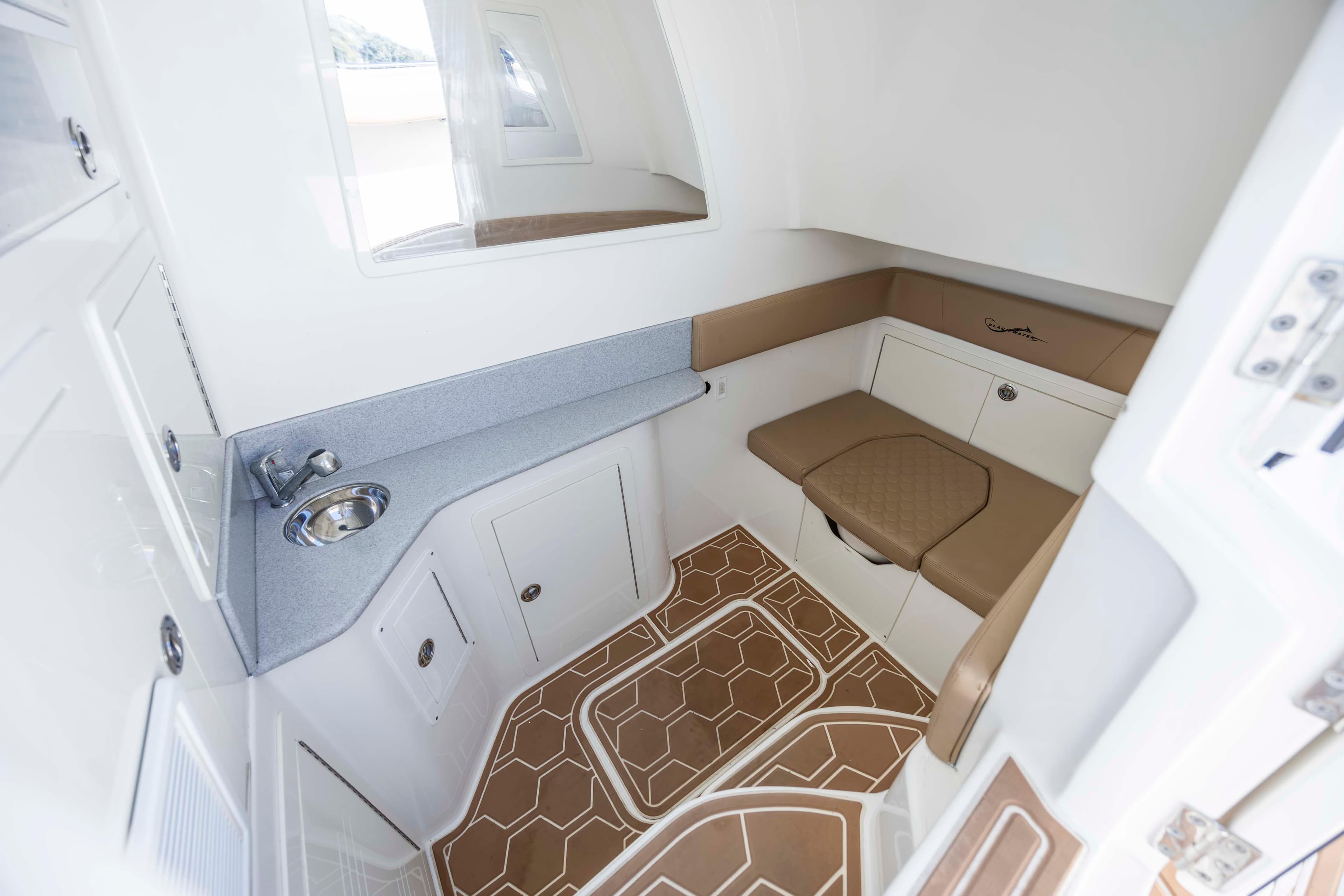 2020 Blackwater 41 Tournament cabin interior with sink, seating, and storage.
