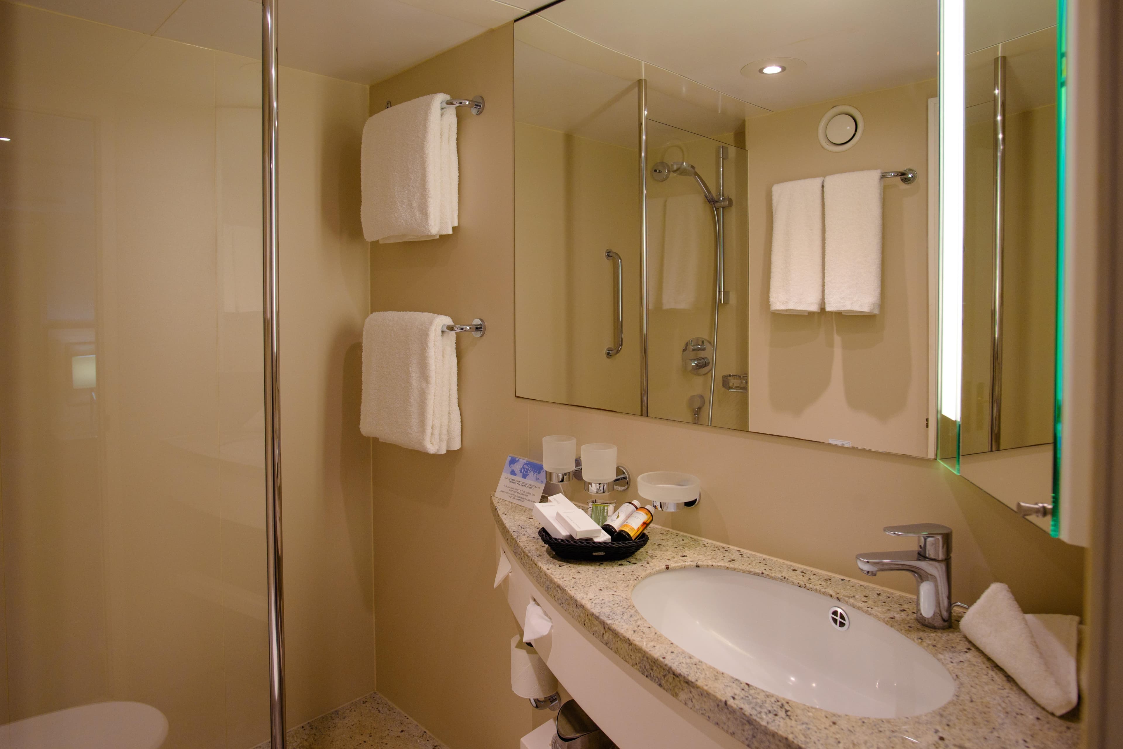 Luxurious bathroom on 1996 Minerva cruise ship with modern amenities and elegant design.