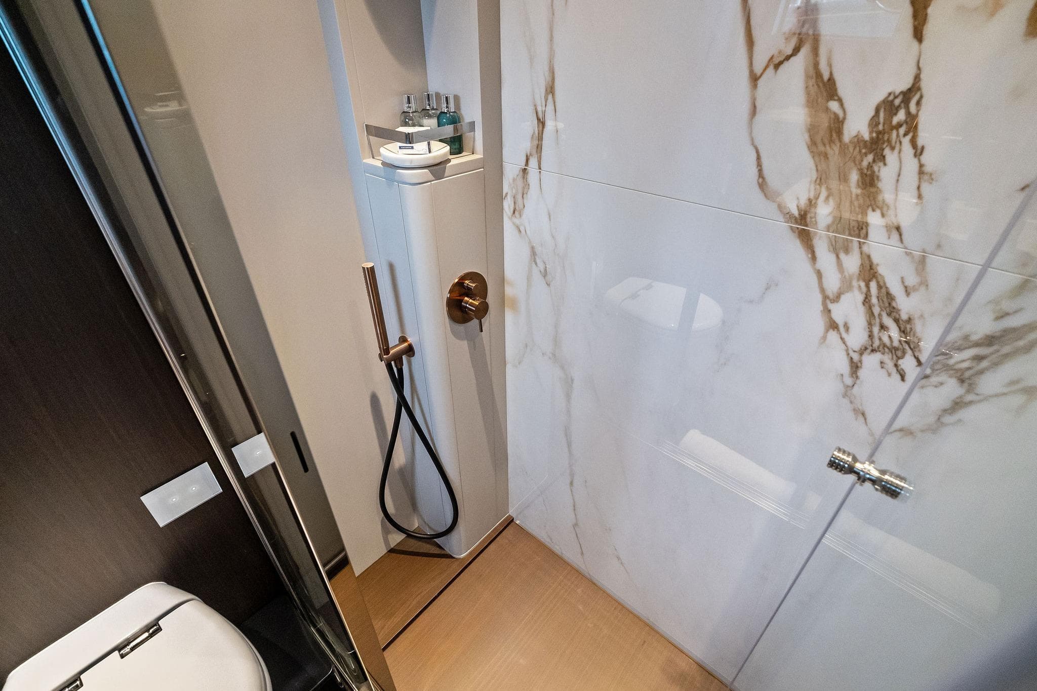 Luxurious bathroom in 2023 Ferretti Yachts 860 with marble walls and modern fixtures.