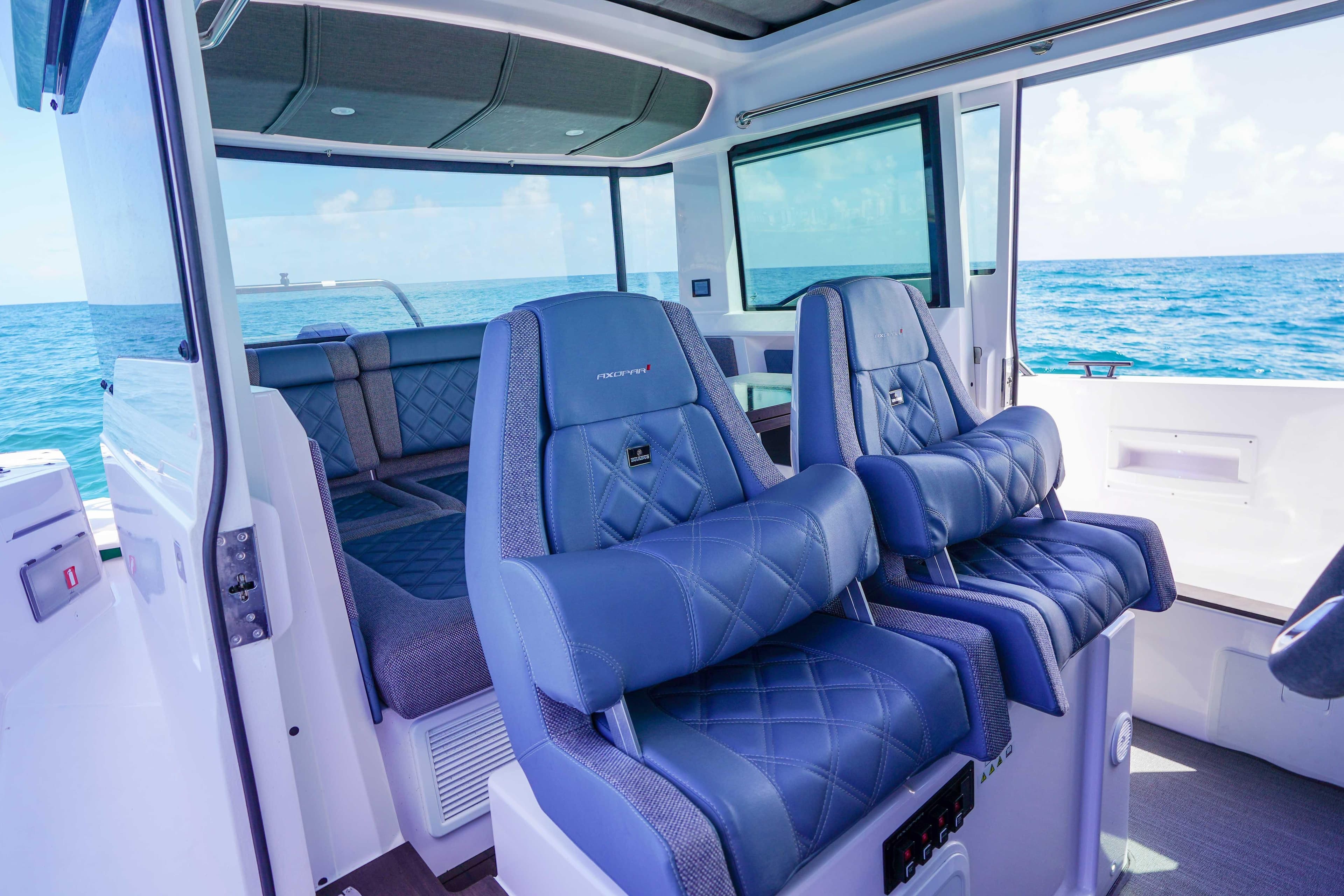 2024 Axopar 37 XC Cross Cabin interior with luxurious blue seating and ocean view.