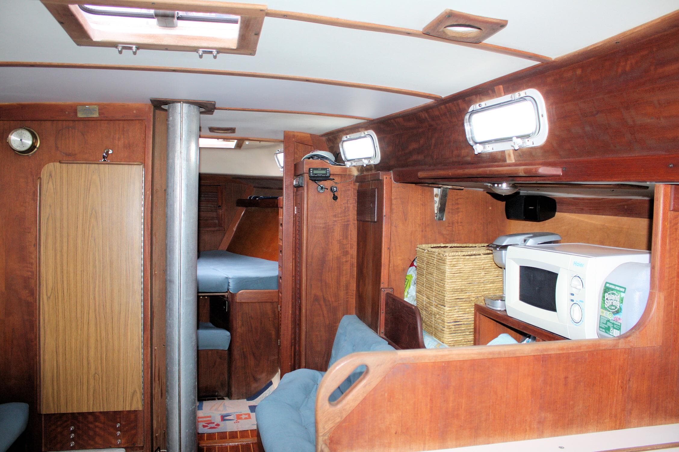 1978 Tartan 37 sailboat interior with wood finish, seating, and kitchenette featuring a microwave.