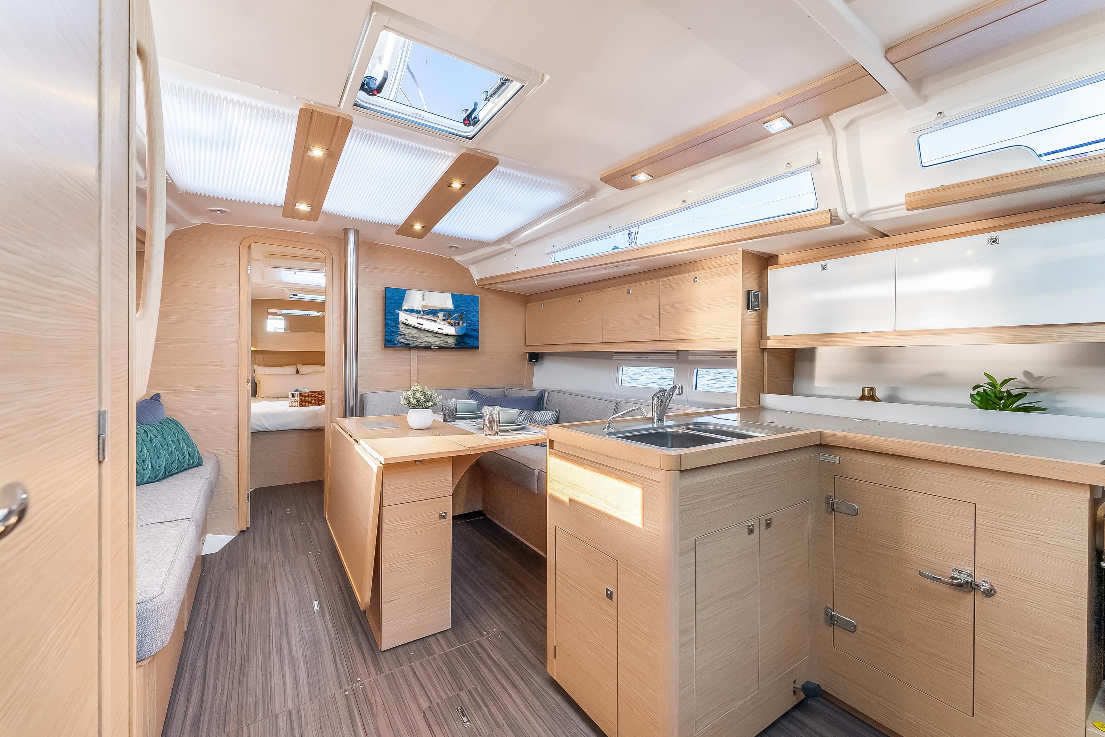 Modern interior of 2023 Dufour 390 yacht with sleek kitchen and seating area.
