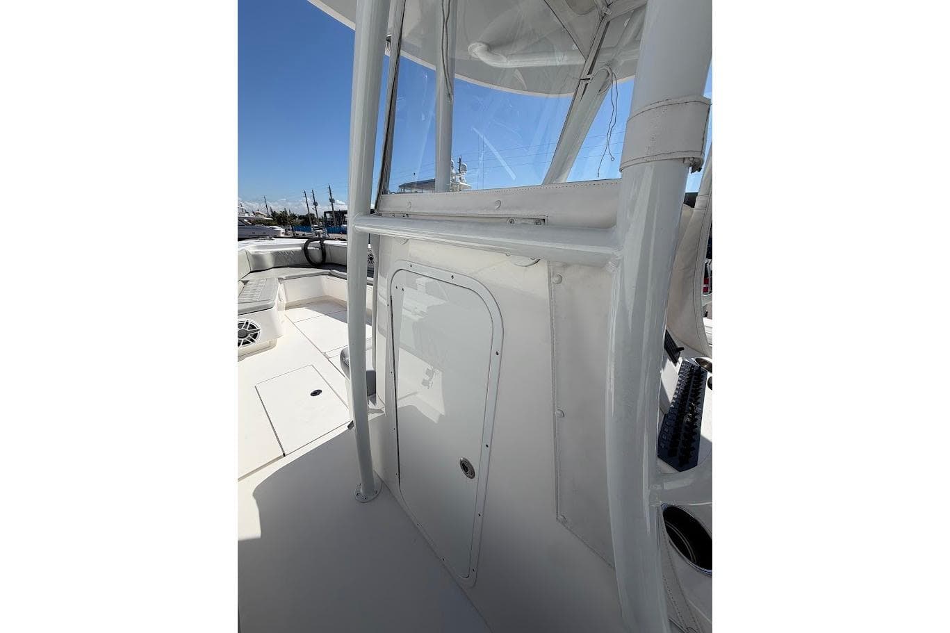 2021 Contender boat interior with white console and seating area under clear blue sky.