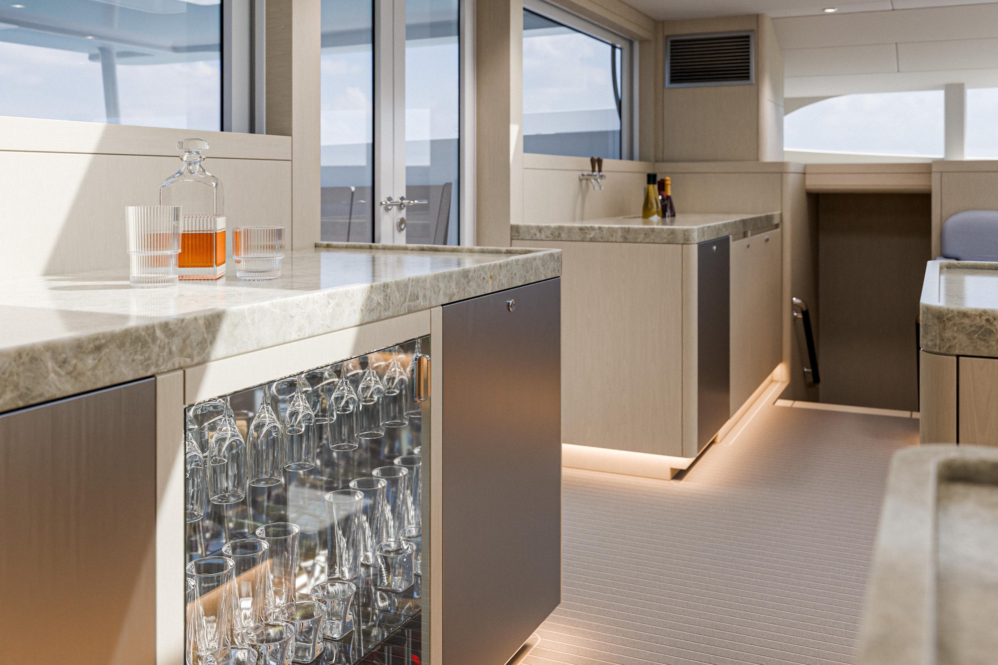 Luxurious interior of 2027 Ocean Explorer Catamarans 72, featuring modern kitchen and glassware display.