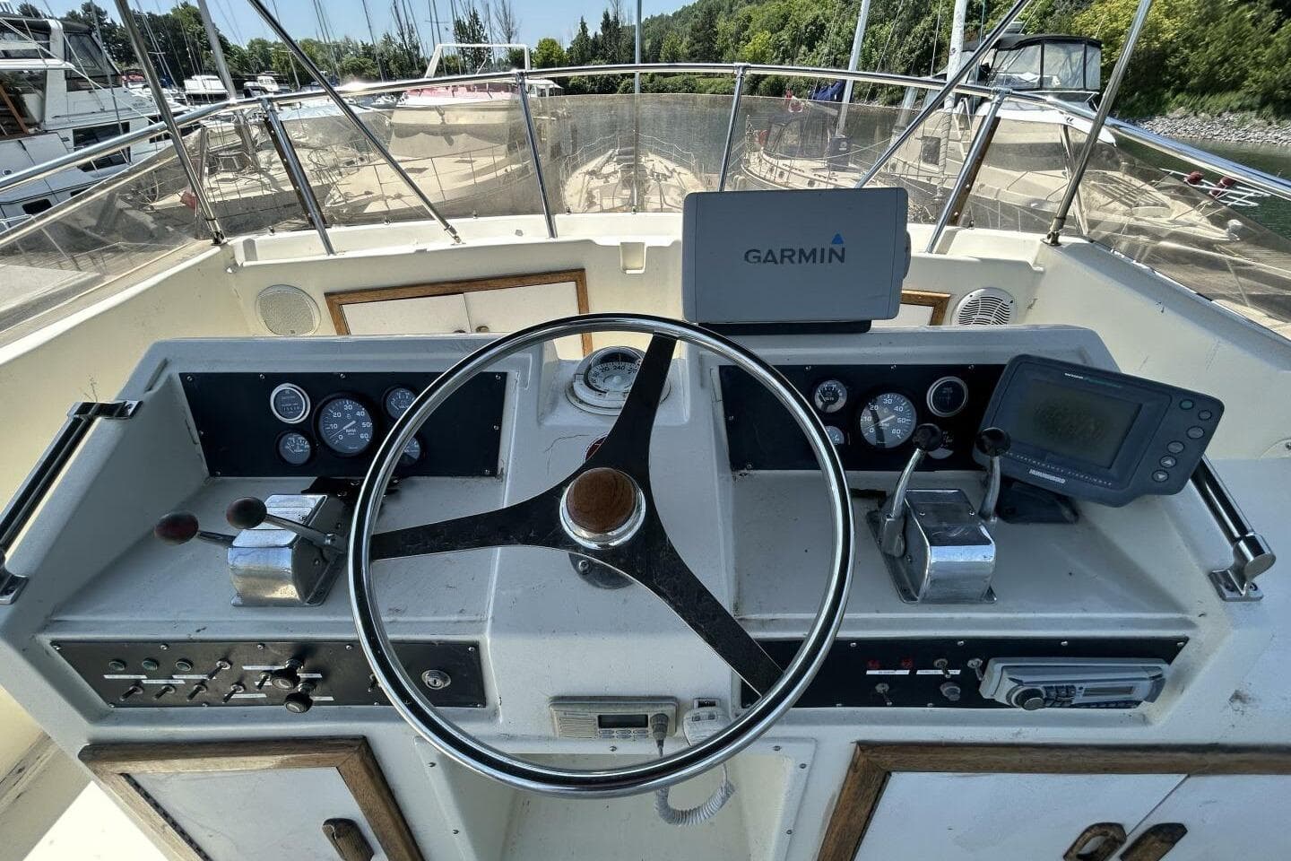 1984 Hatteras 36 Convertible helm with Garmin navigation system and control panel.